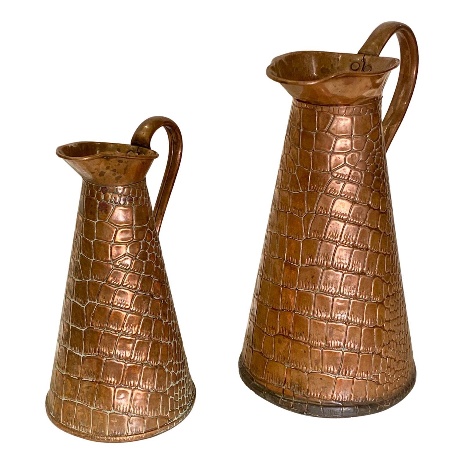 A pair of 1920's English copper jugs with crocodile skin pattern on the body and original patina.

Measurements:
Larger - Height: 13