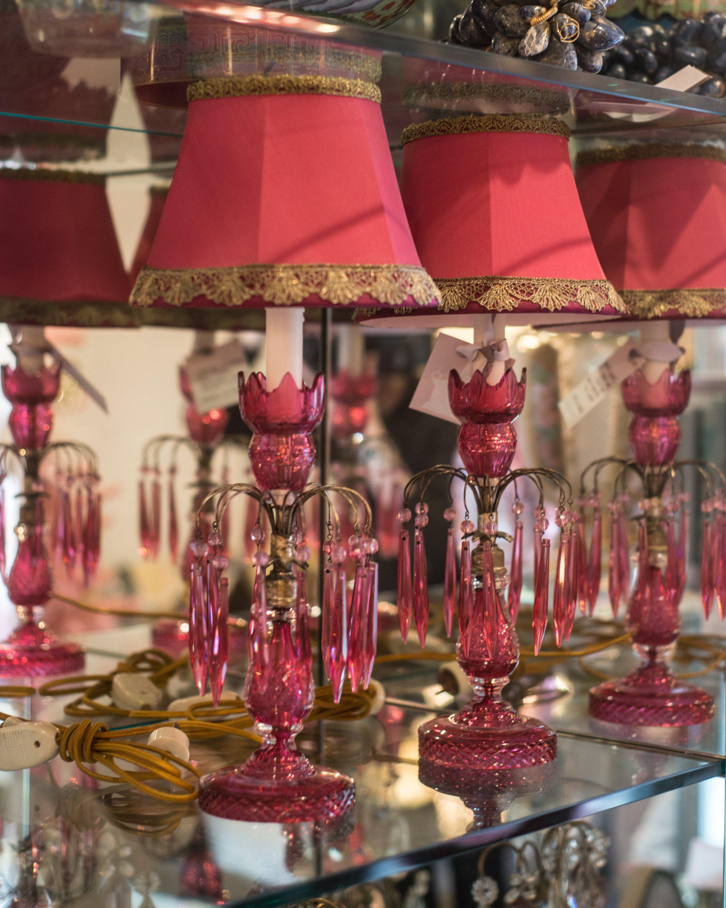 Imagine this whimsical pair of delicate antique cranberry crystal lamps decorating your nightstands. These beautiful lamps are newly rewired and finished with matching custom handmade cranberry silk shades and metallic vintage trim.