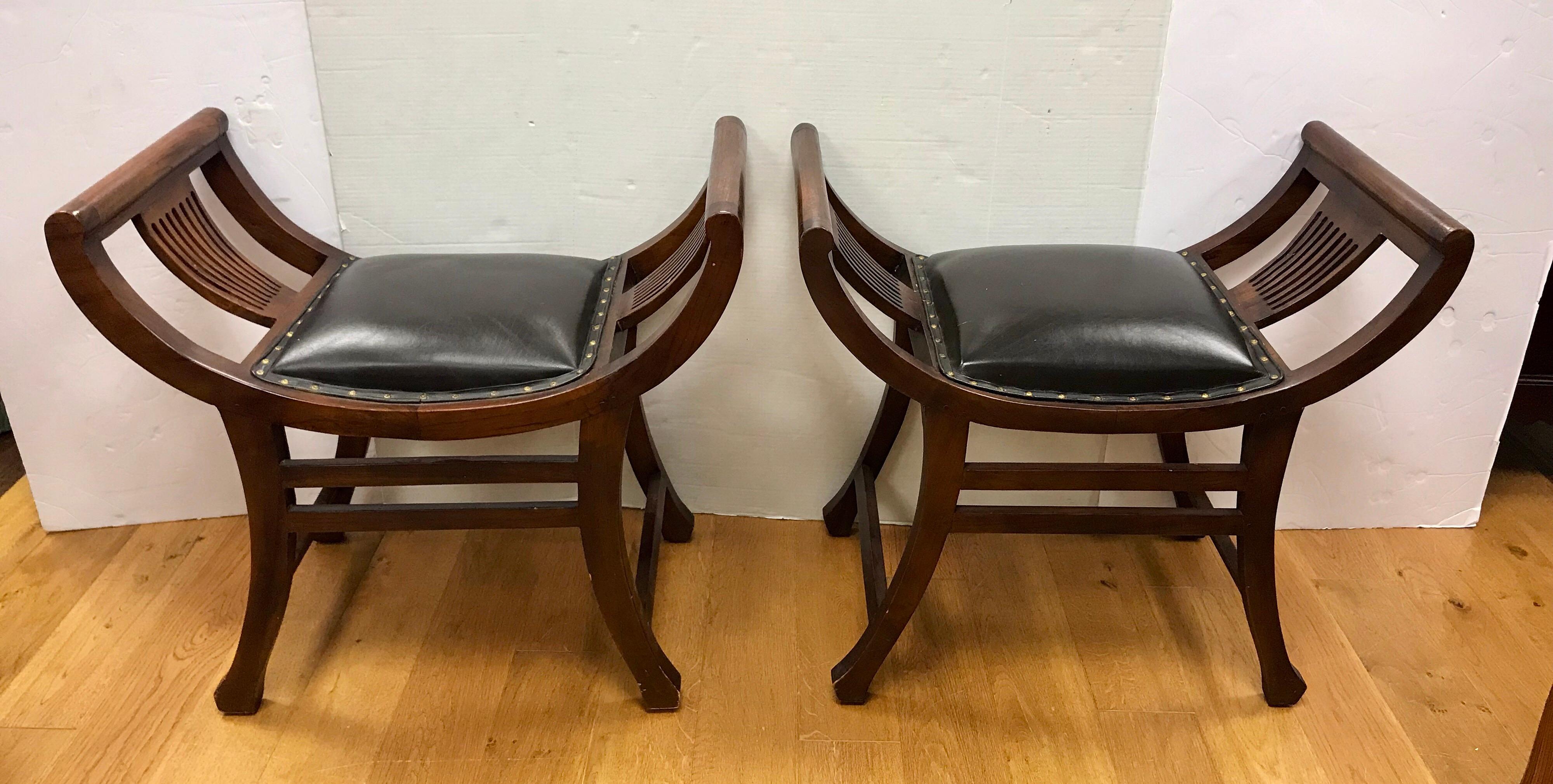 Coveted matching pair of English leather slatted benches or stools with black leather seats and studs. They are supported with a gorgeous mahogany frame, circa late 19th century, England.