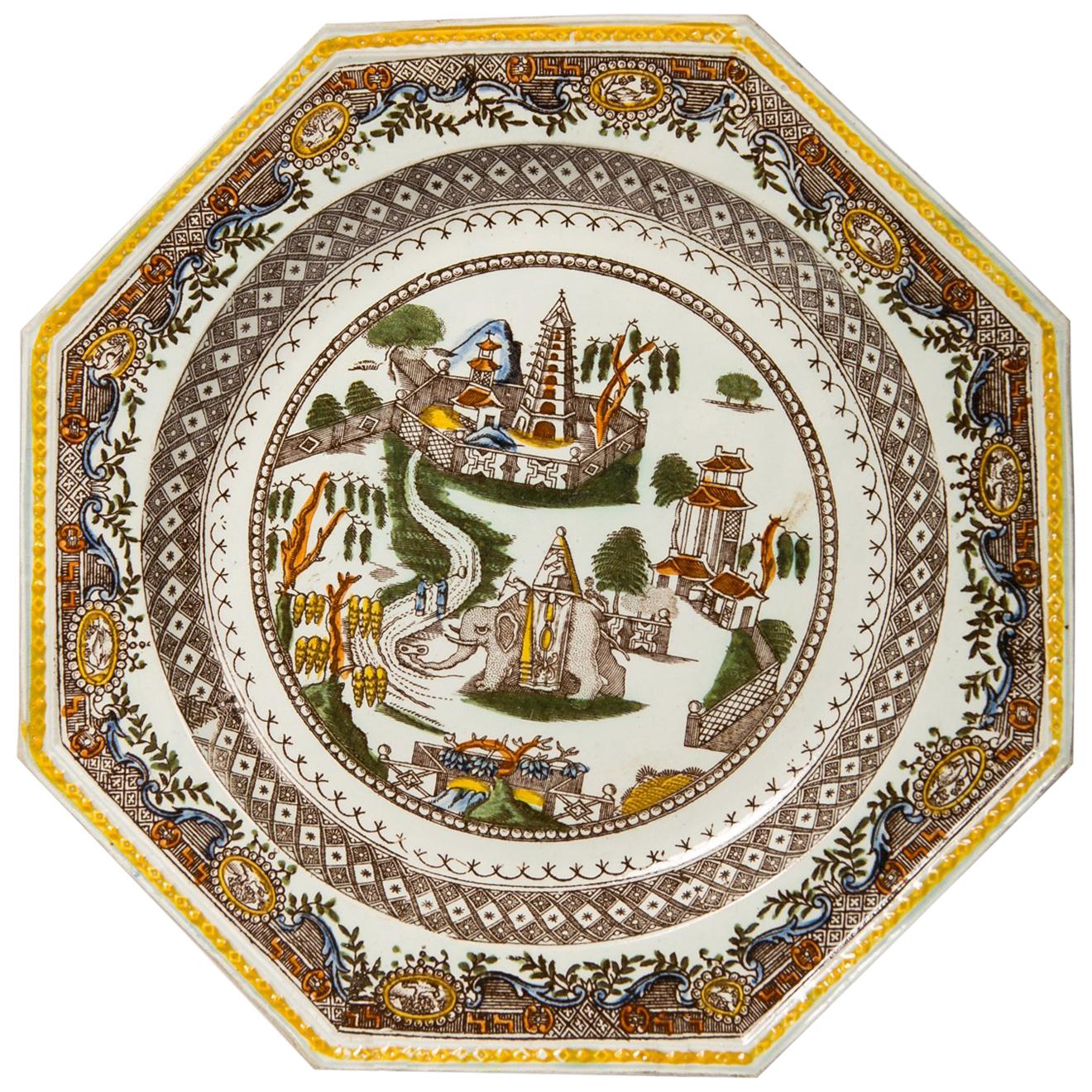 This pair of antique English dishes show a fabulous bird's eye view of an elephant in an imaginary Asian setting.
 Two figures ride an Indian elephant through an exotic landscape. Along a winding road, we see large fruit trees, fenced gardens, a