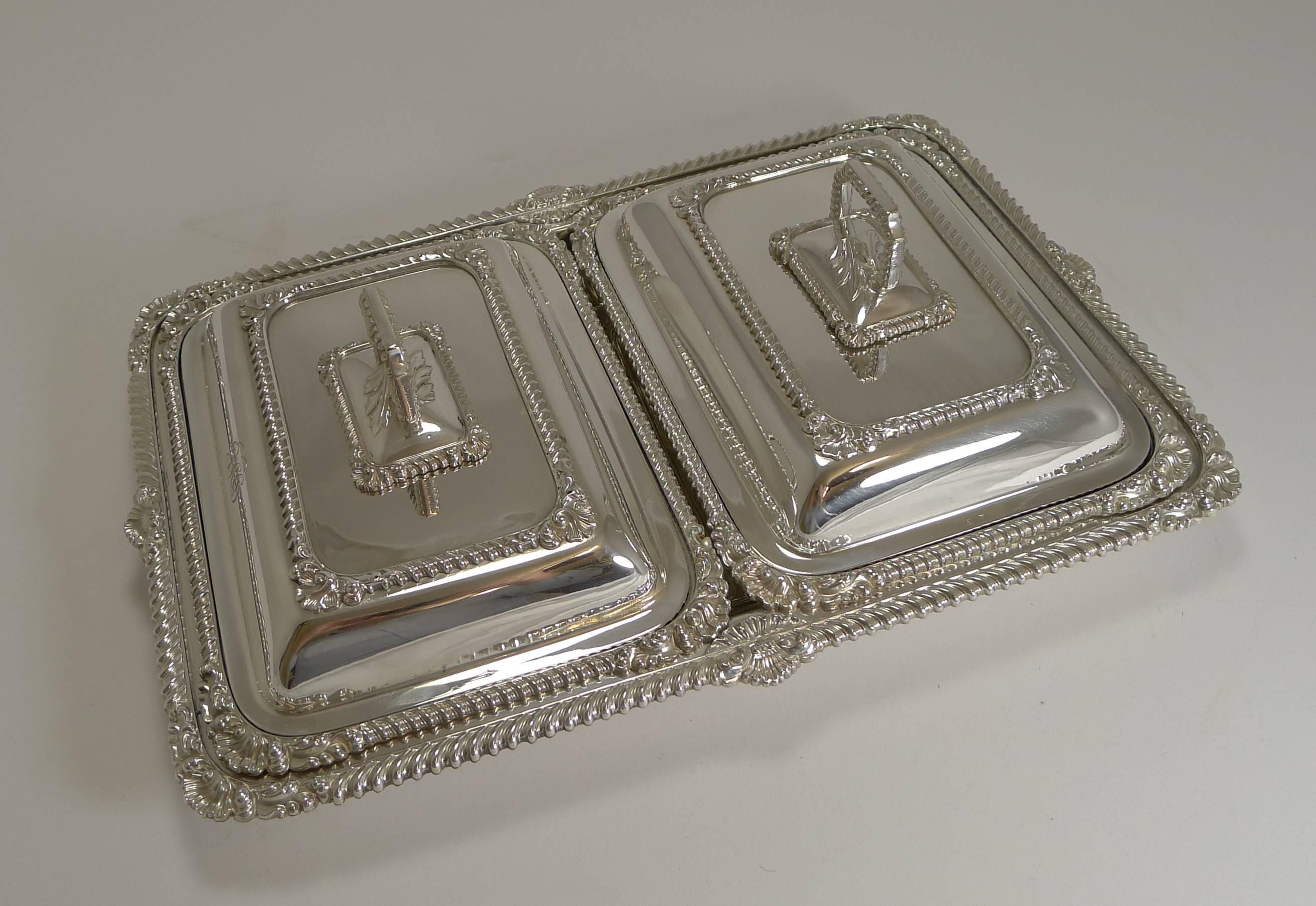 A most unusual serving set by the top quality English silversmith, James Dixon and Sons of Sheffield. The hallmark can be found on the underside of the two removable handles.

There are two small entree dishes which sit in one large dish. The