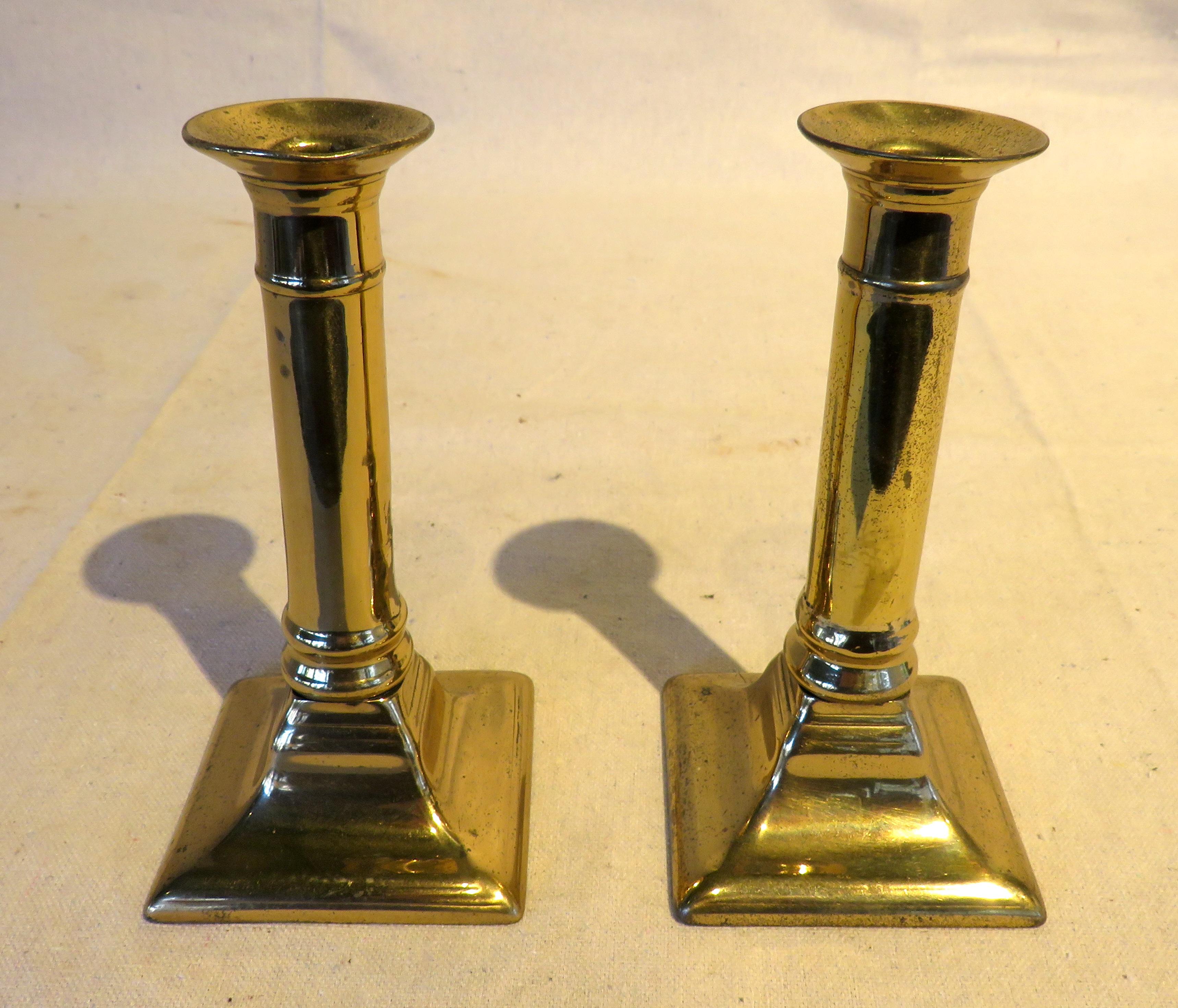 Pair of diminutive Federal brass candlesticks with push-up mechanism from England.