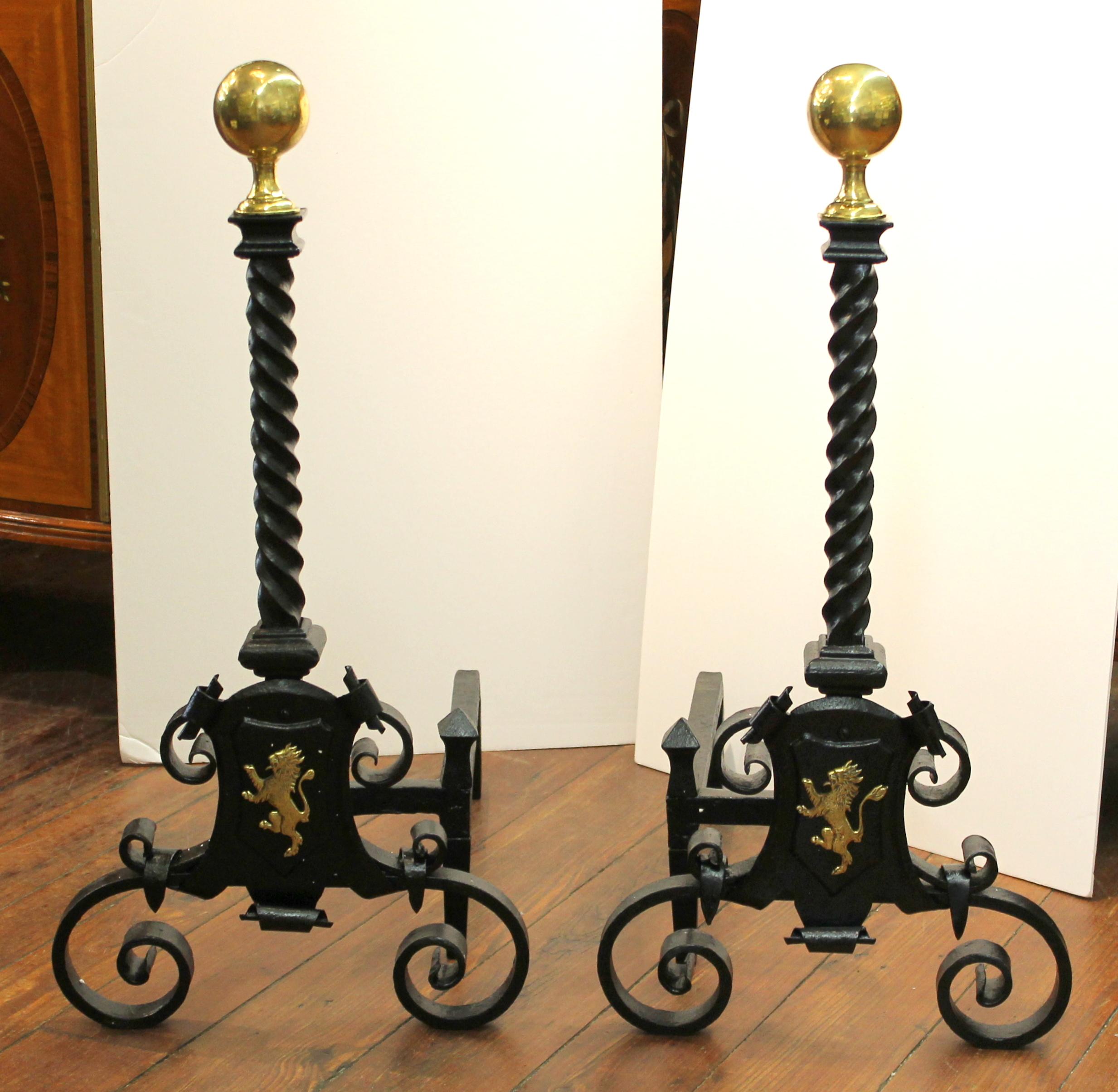 Pair of exceedingly fine antique English handwrought iron and cast brass monumental andirons with lion rampant motif.

Please note superbly handwrought heavy iron work.