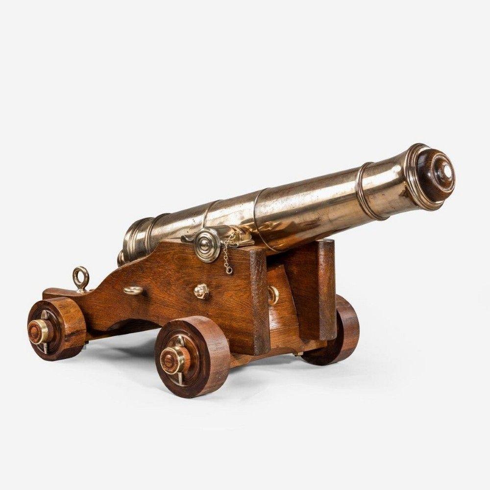 Pair of antique English naval cannon each with a tapering three stage barrel flanked by plain trunnions, with a knob shaped cascabel button before a shaped rectangular raised vent and ending in a 3 1/2” bore muzzle, enclosing a removable conforming