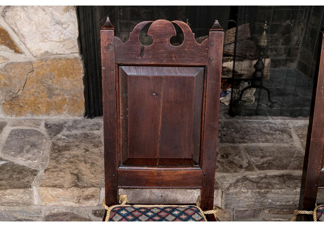 Carved Pair Of Antique English Oak Jacobean Style Hall Chairs For Sale