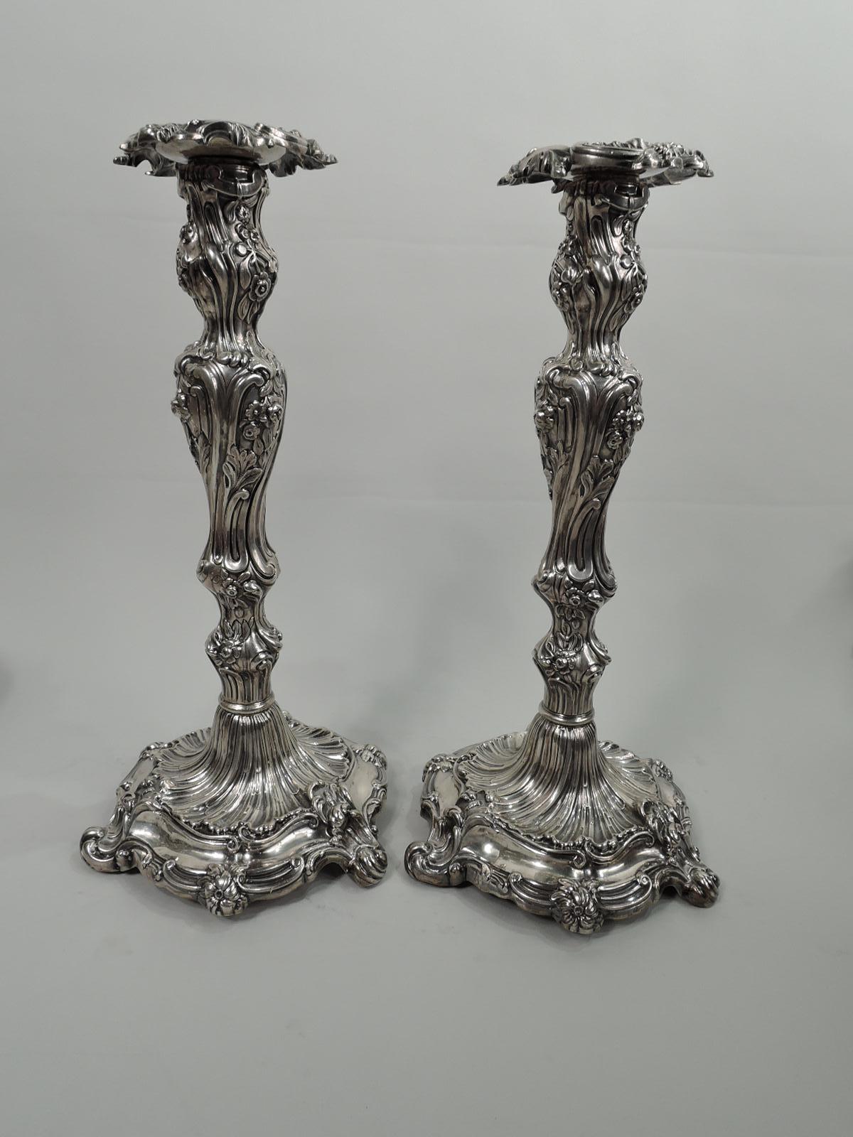 Pair of English Rococo sterling silver 5-light candelabra. Each: Knopped baluster shaft on round shaped base on 3 scrolled supports. Arms comprise central baluster shaft and 4 s-scrolled arms, each terminating in single socket on wax pan. Sockets