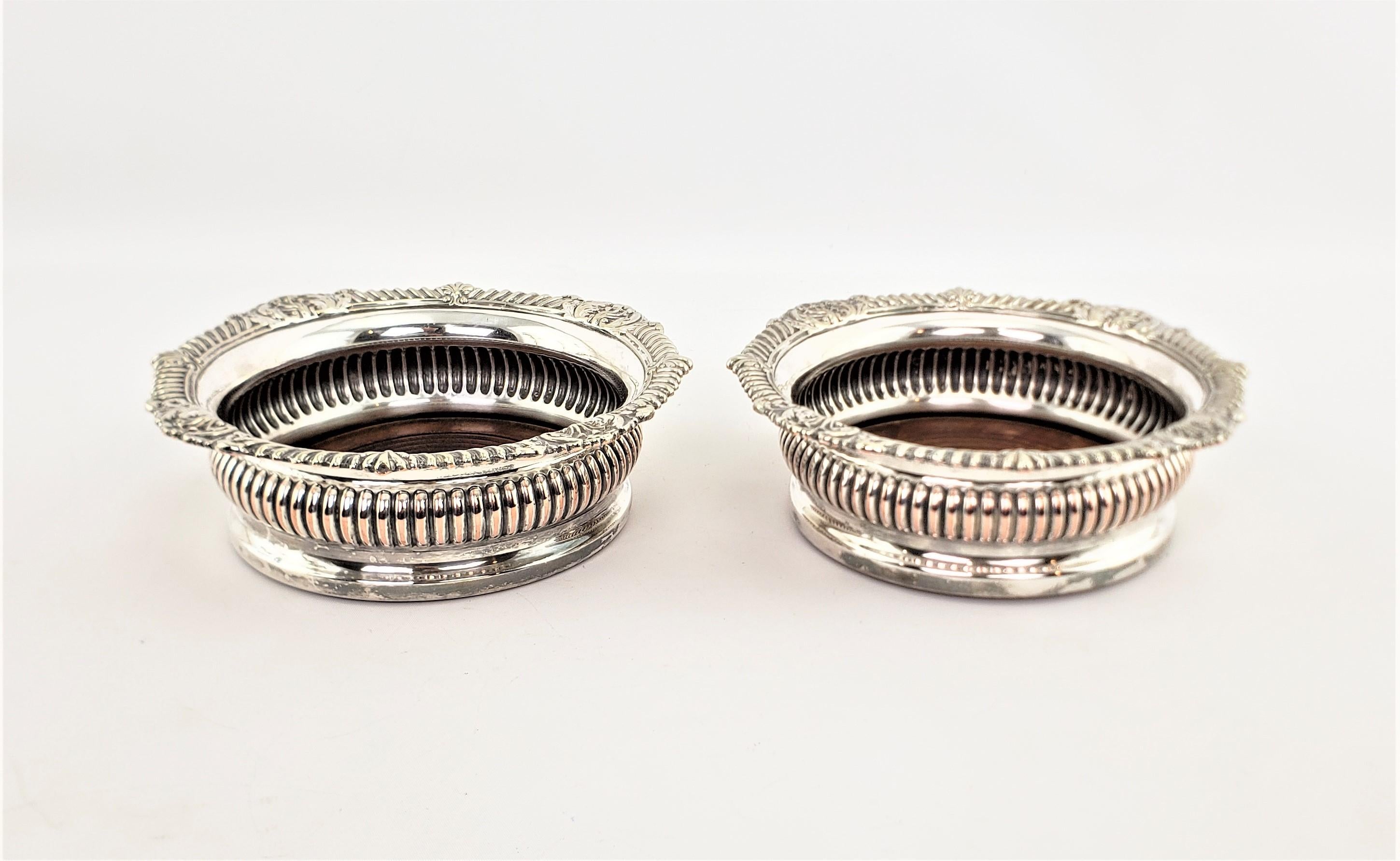 Victorian Pair of Antique English Silver Plated Bottle Coasters with Turned Wooden Inserts For Sale