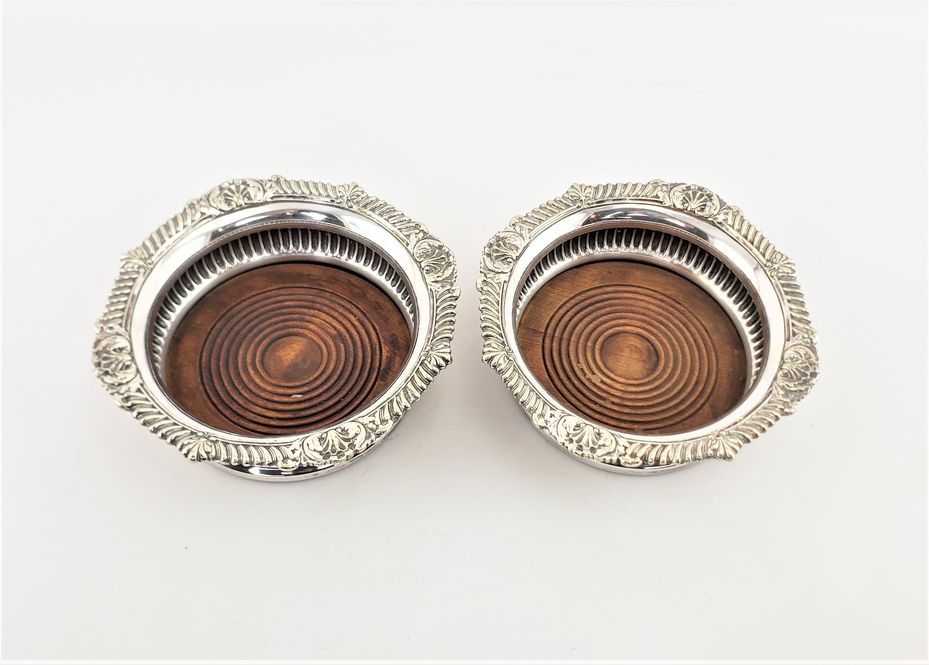 Machine-Made Pair of Antique English Silver Plated Bottle Coasters with Turned Wooden Inserts For Sale