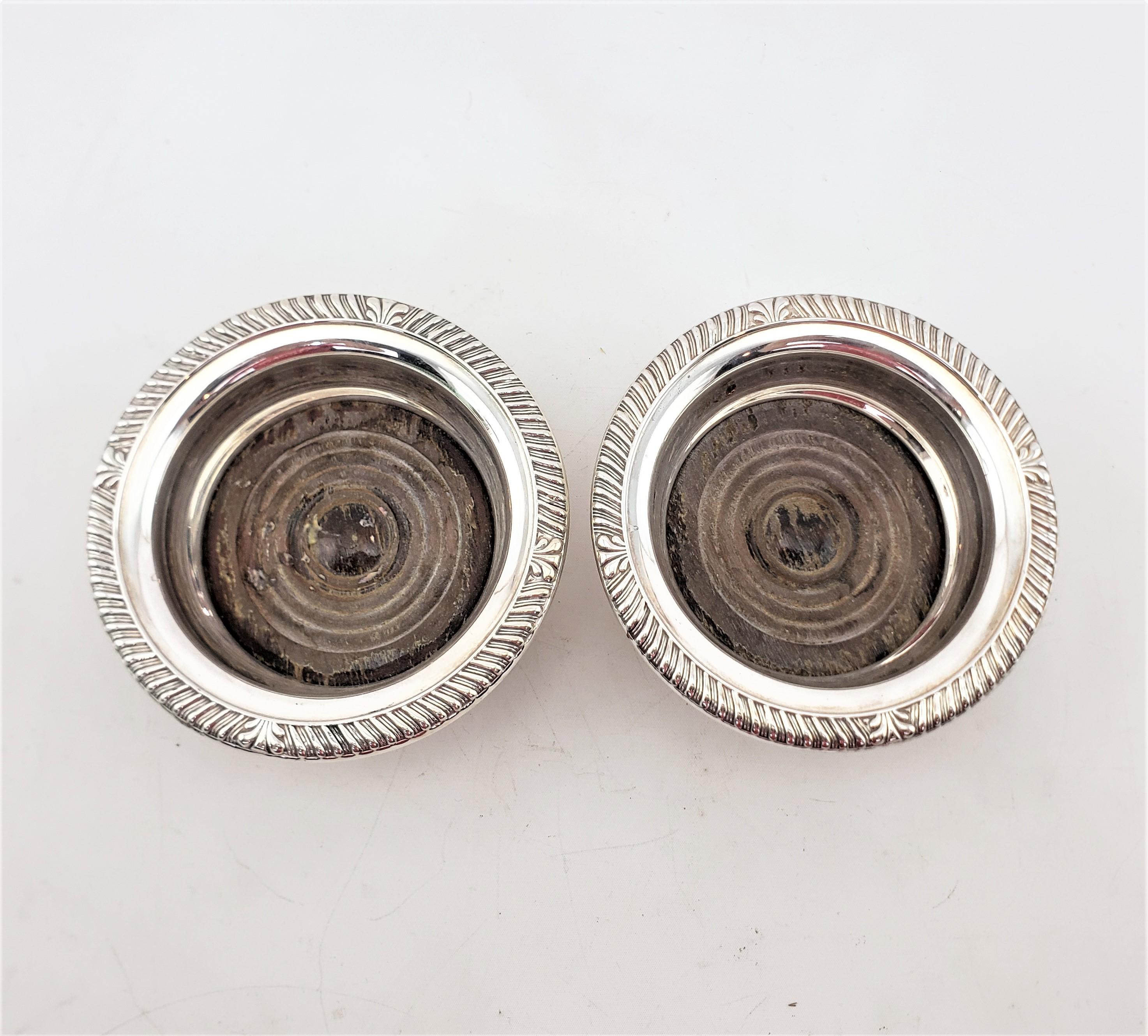 20th Century Pair of Antique English Silver Plated Bottle Coasters with Turned Wooden Inserts For Sale