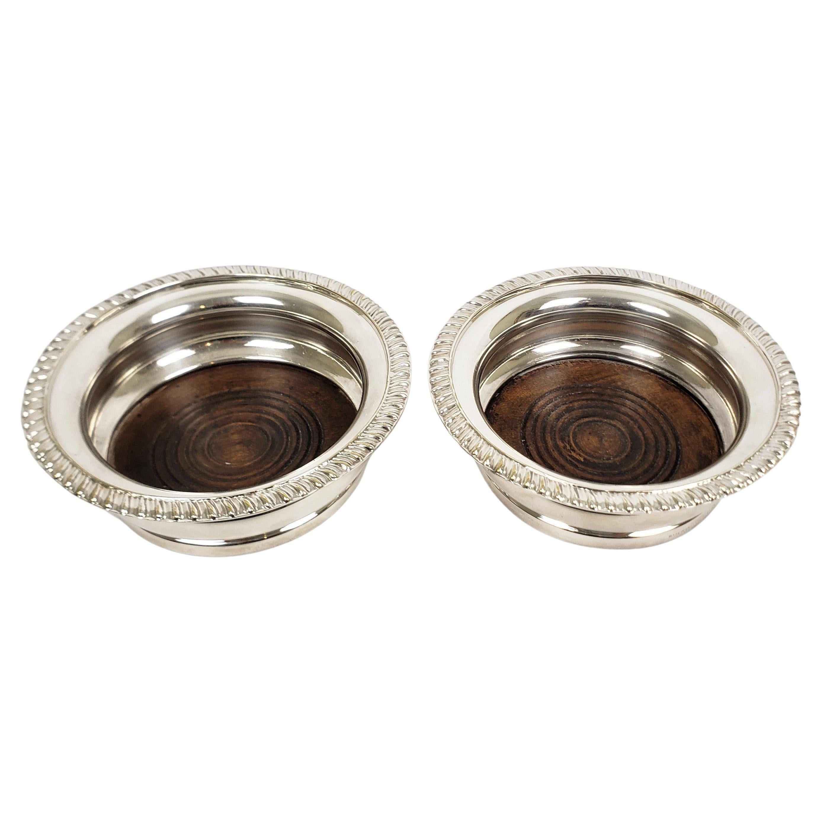 Pair of Antique English Silver Plated Bottle Coasters with Turned Wooden Inserts For Sale