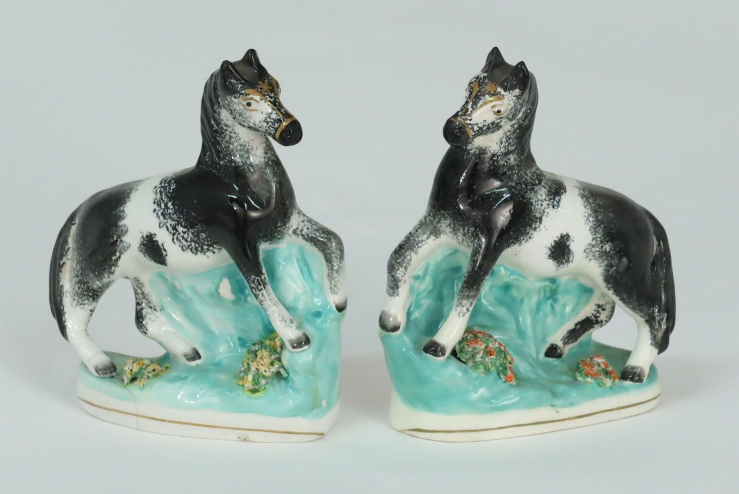 A charming pair of antique English Staffordshire black and white horses with unusual gilt decoration to their faces, circa 1850 (From the owner's private collection).