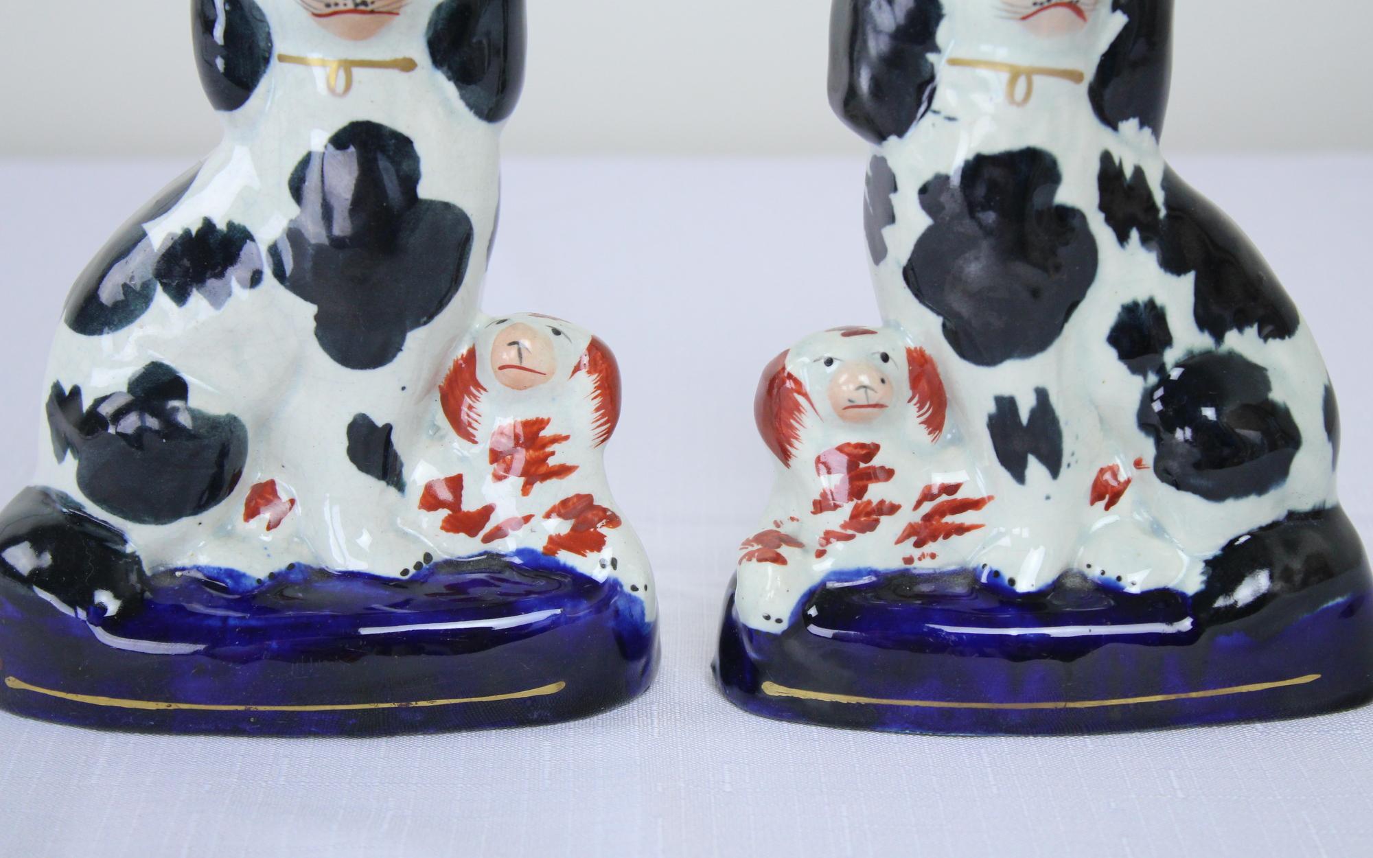 A small charming pair of decorative dogs from the late 19th century English potteries. hand-painted, with subtle differences in the faces and spots. Highly decorative but no stamp or obvious markings on the bottom.