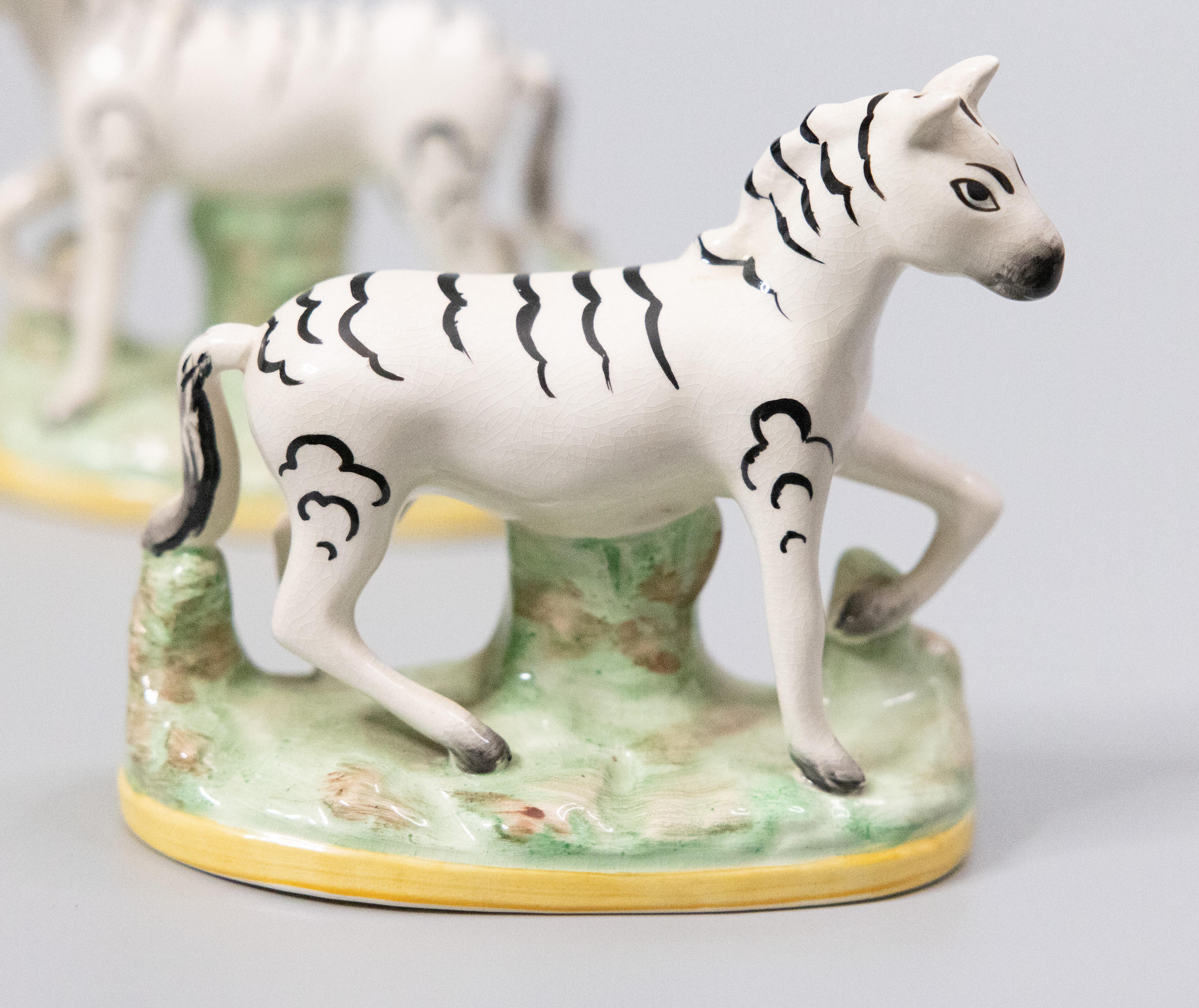 A superb pair of antique English Staffordshire zebra figurines, circa 1920. These charming zebras are hand painted with fine details and would be perfect for display or added to a collection.