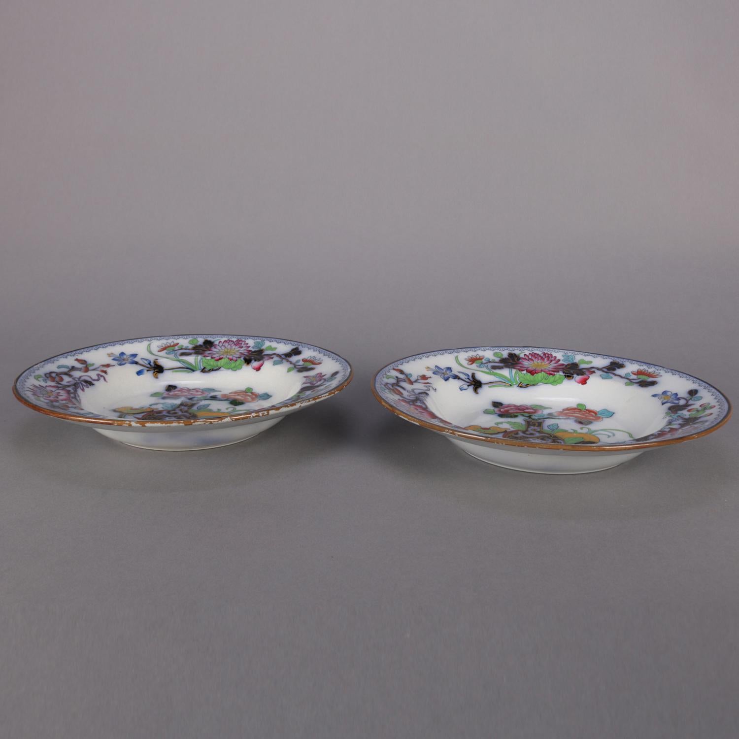 Pair of antique English Wedgwood Noma pattern ironstone bowls feature polychromed, flow blue and gilt Asian floral and urn decoration, one en verso marked NOMA, mid-1800s.

Measures: 1.75