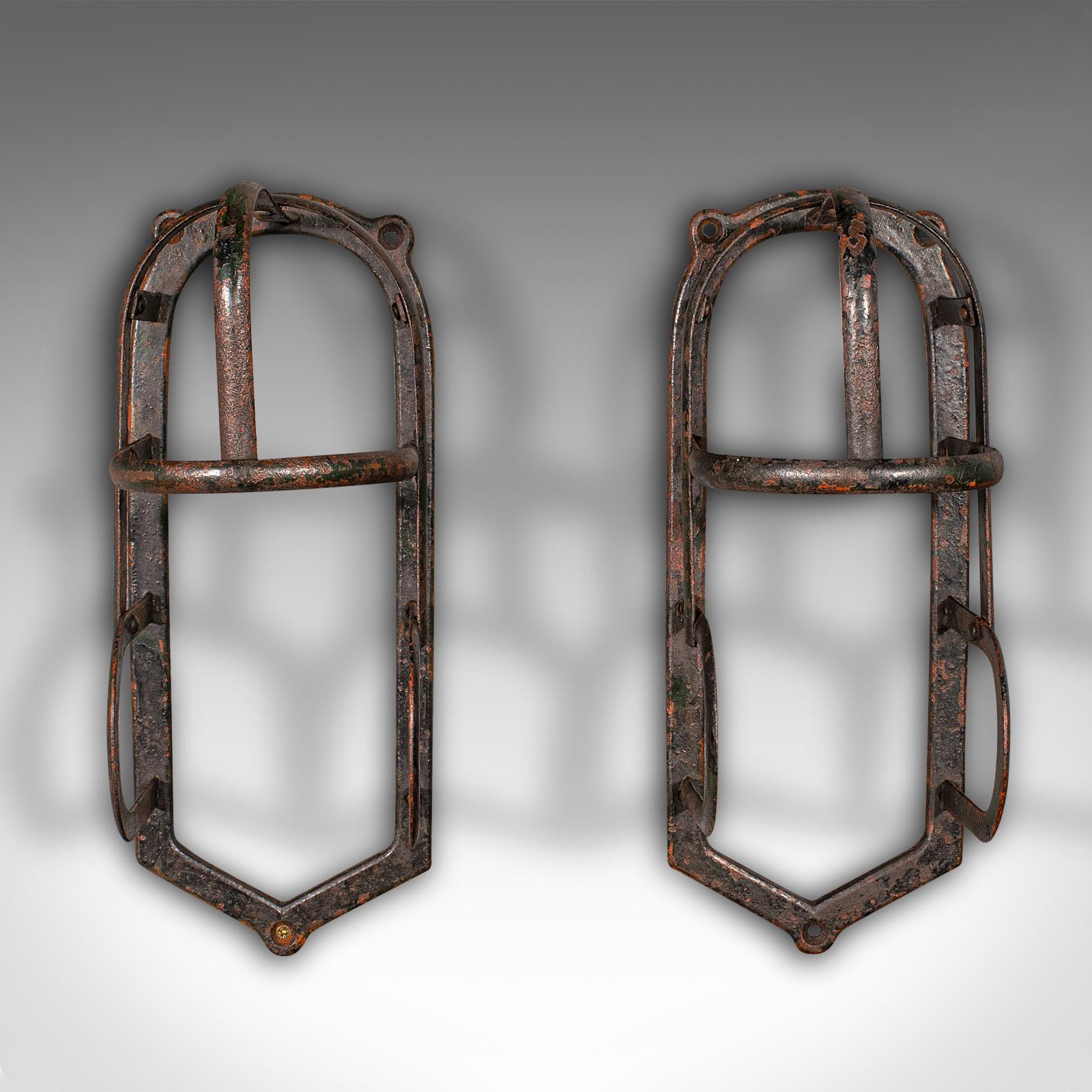 This is a pair of antique equestrian tack rests. An English, cast iron stable or outdoor rack, dating to the late Victorian period, circa 1900.

Fascinating dome top form to this appealing pair of rests
Displaying a desirable aged patina with time