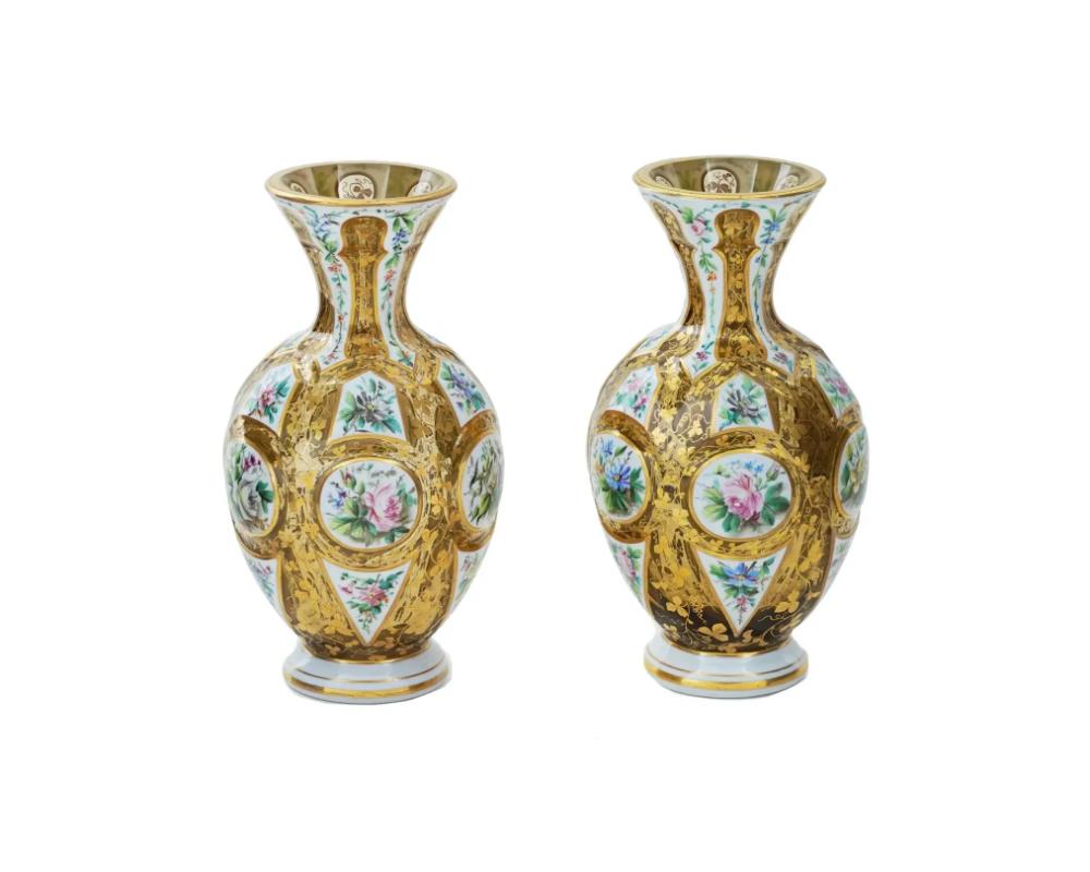 A pair of European Bohemian hand blown glass vases of a baluster shape, richly decorated with gilding, partly covered with white enamel and hand painted with beautifully detailed floral designs. Circa 1880. Antique and Vintage Bohemian Glass Vases,