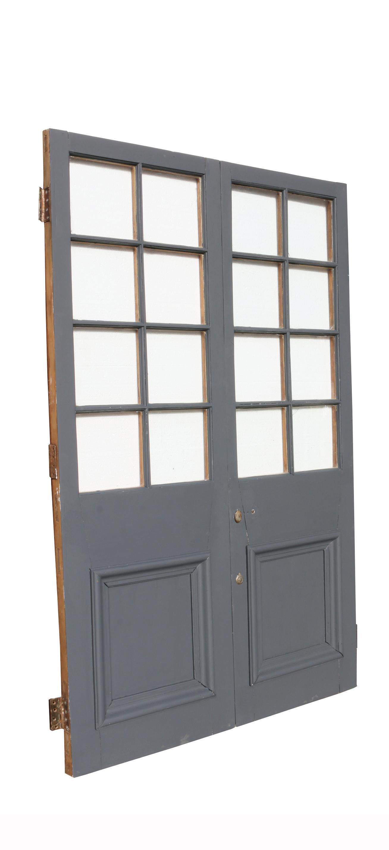 These doors have been painted on one side in a grey primer and feature single glazing. They are in good condition for their age, but do have four cracks to the glass.

Measures: Height 197.5 cm

Width 124.5 cm

Depth 5 cm

Weight 45 kg (for