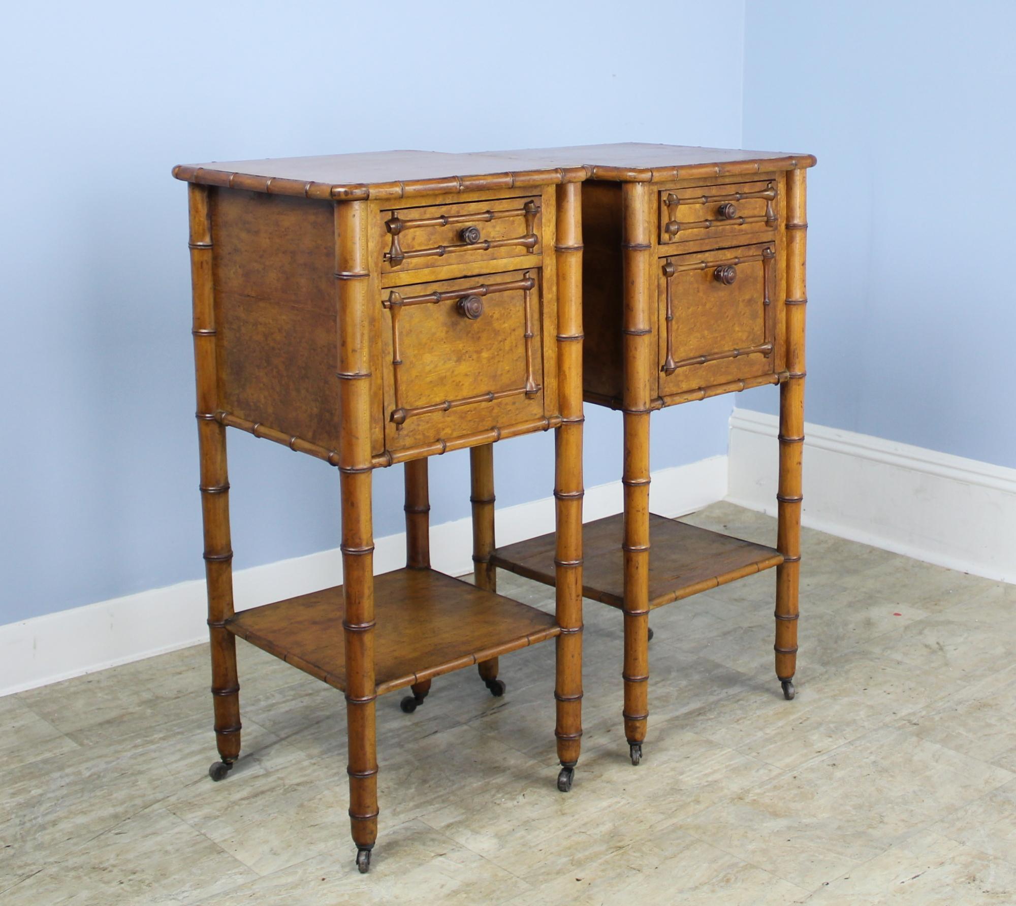 A charming pair of faux bamboo night stands or side tables with lots of bamboo detail. Each has a small top drawer and roomy lower compartment with a drop down door. Useful lower shelf and original castors.