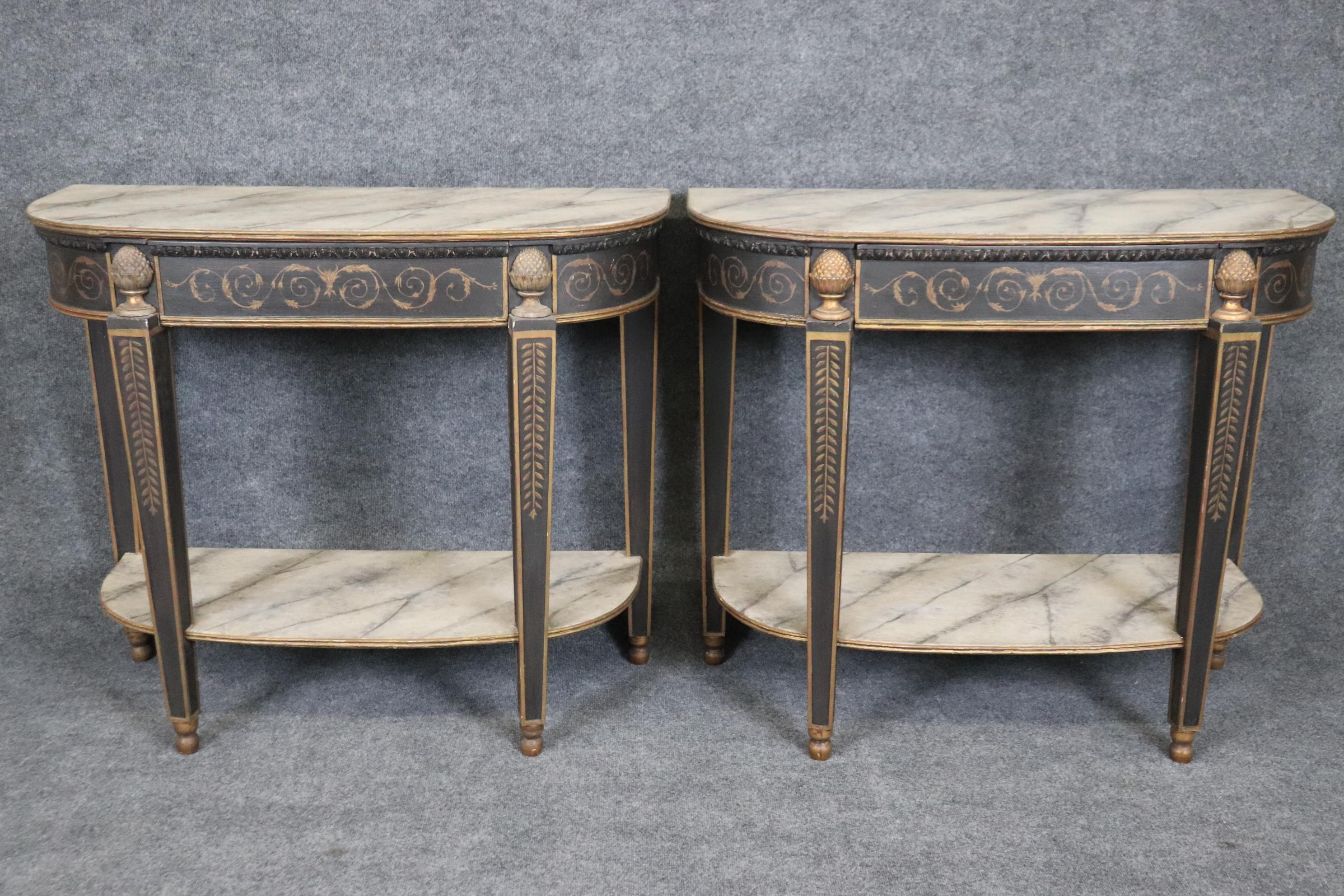 This is a superb pair of original antique French Directoire paint decorated console tables. The tables are faux painted in the top and lower tiers to look like marble and have a nice original patina to the original finish. The tables are in good