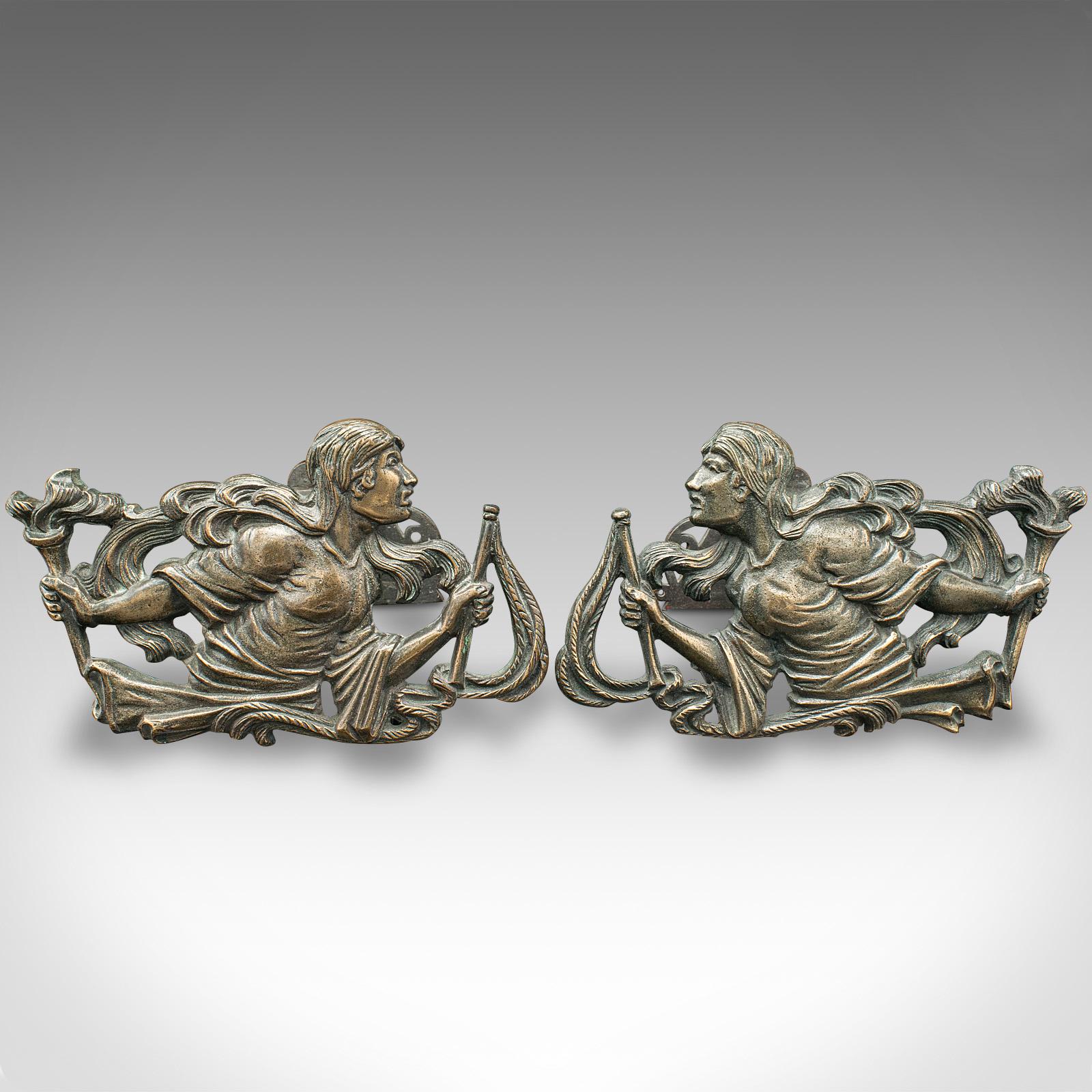 This is a pair of antique figural andirons. A French, bronze decorative fireside tool rest with female form in country house taste, dating to the late Victorian period, circa 1850.

Strikingly decorative fireside interest with fine