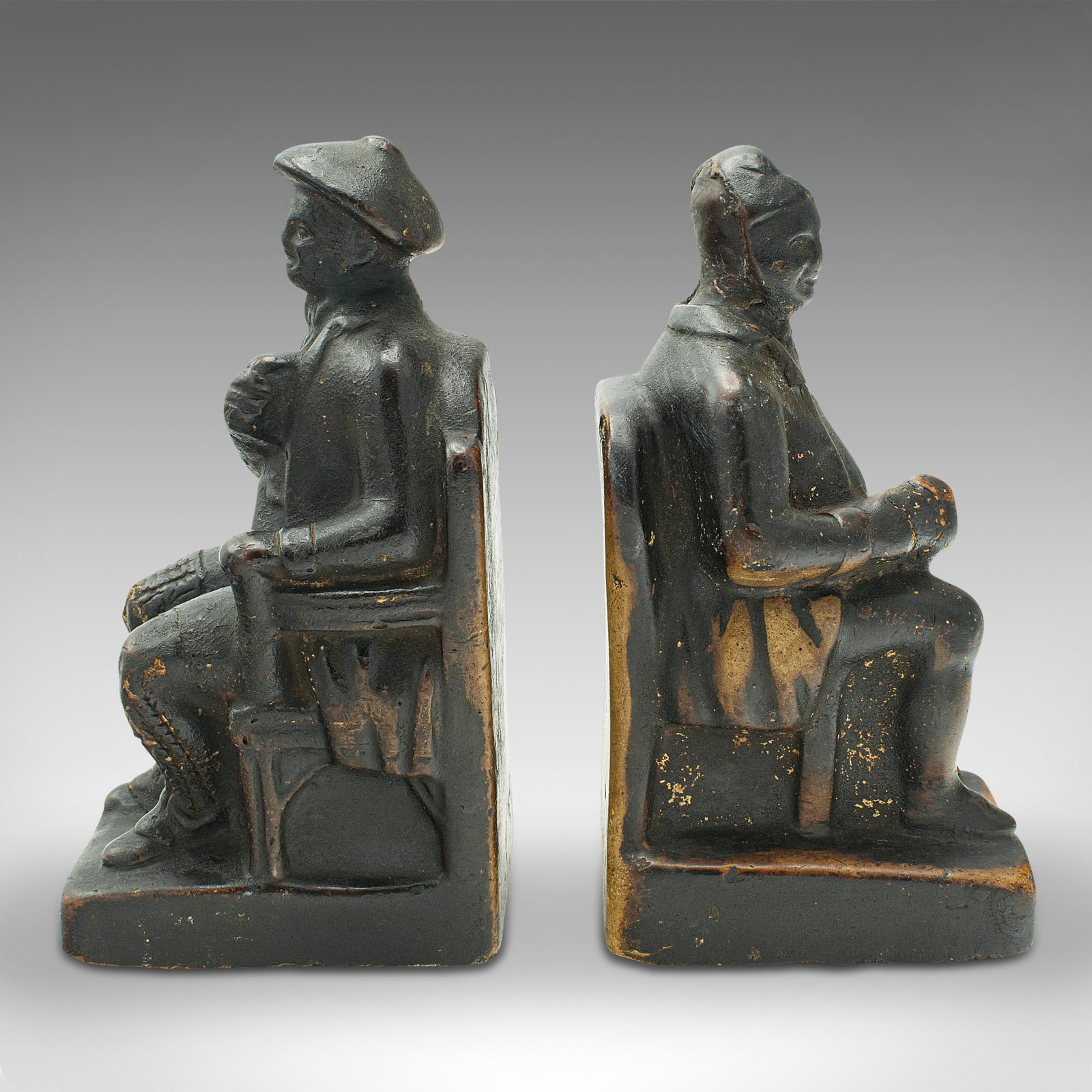 This is a pair of antique figurative bookends. A Dutch, plaster seated man and woman book rest, dating to the late Victorian period, circa 1900.

Appealing example of Dutch craftsmanship, with jovial character
Displaying a desirable aged patina