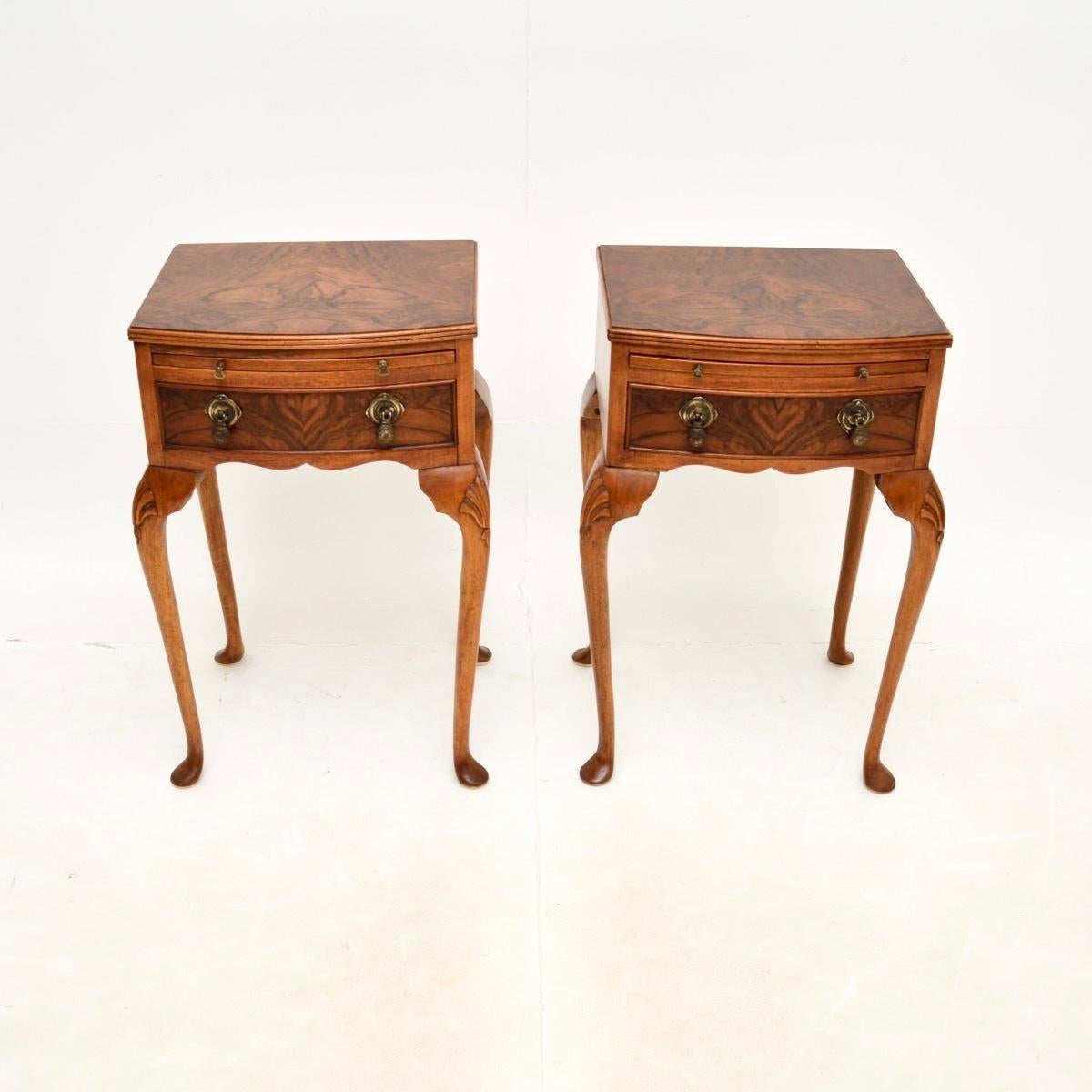 A beautiful and very impressive pair of antique figured walnut bedside tables. They are in the Queen Anne style, they were made in England and date from around the 1930’s.

The quality is lovely, they sit on elegant cabriole legs with shell carving