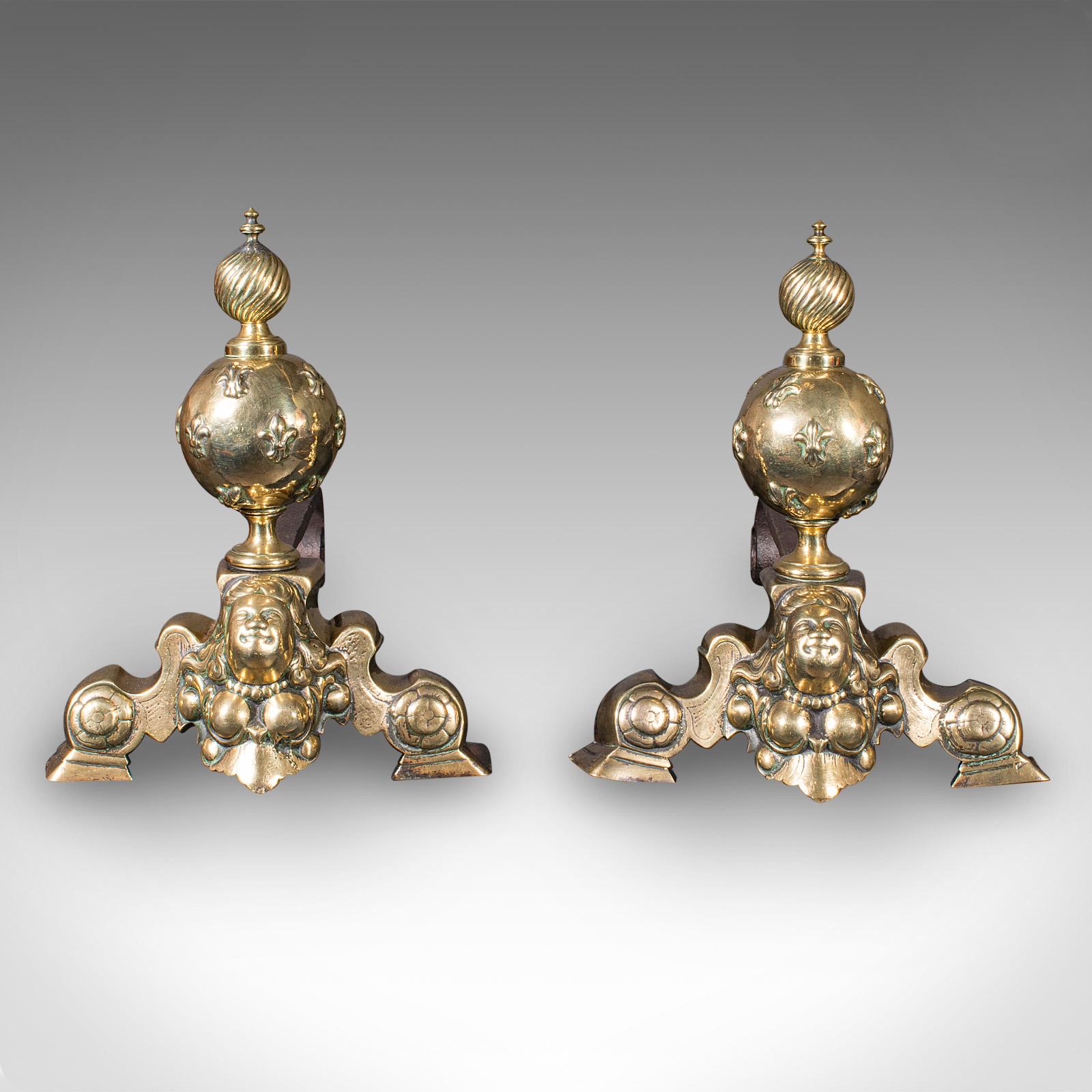 
This is a pair of antique fireside andirons. A French, brass and wrought iron chenet or firedog in Baroque taste, dating to the mid Georgian period, circa 1750.

Fascinating andirons with bold figural appeal and bright tonality
Displaying a