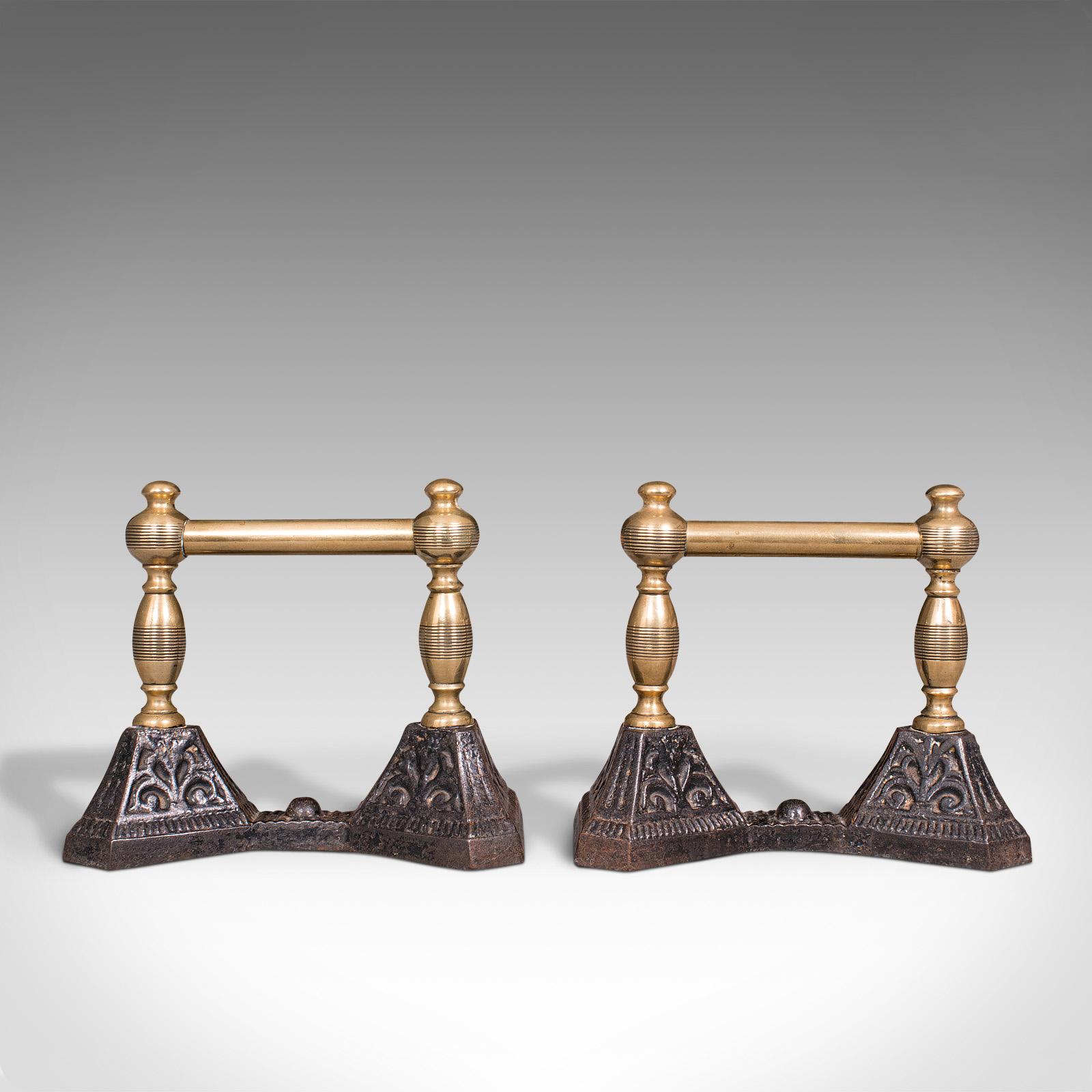 This is a pair of antique fireside tool rests. An English, brass and cast iron fire dog or andiron, dating to the Victorian period, circa 1880.

Appealing antique pair of fireside tool rests
Displaying classical overtones and a desirable aged