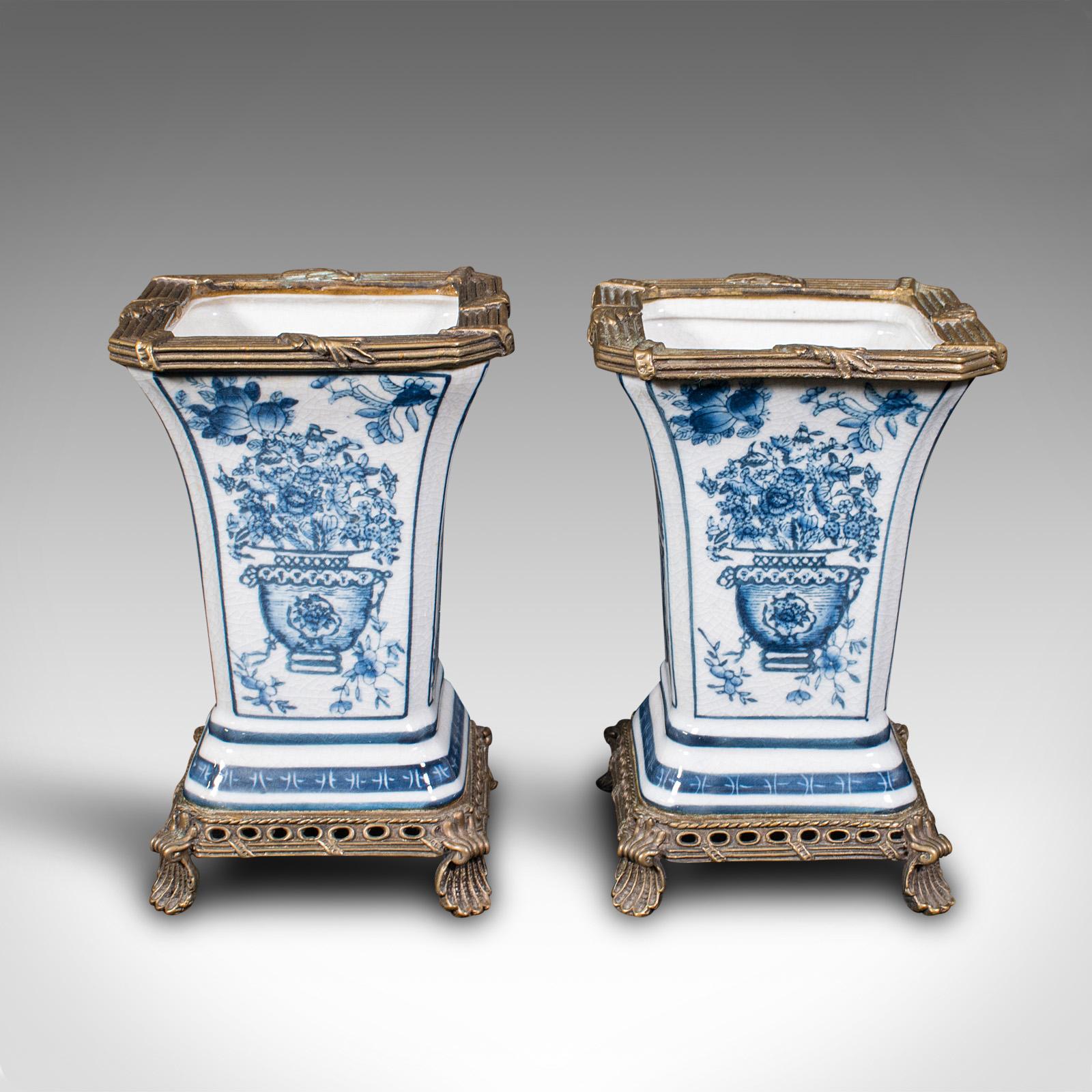 This is a pair of antique flower vases. A Continental, ceramic and gilt metal decorative vase, dating to the late Victorian period, circa 1900.

Appealing blue and white vases with classical decor
Displaying a desirable aged patina throughout
White