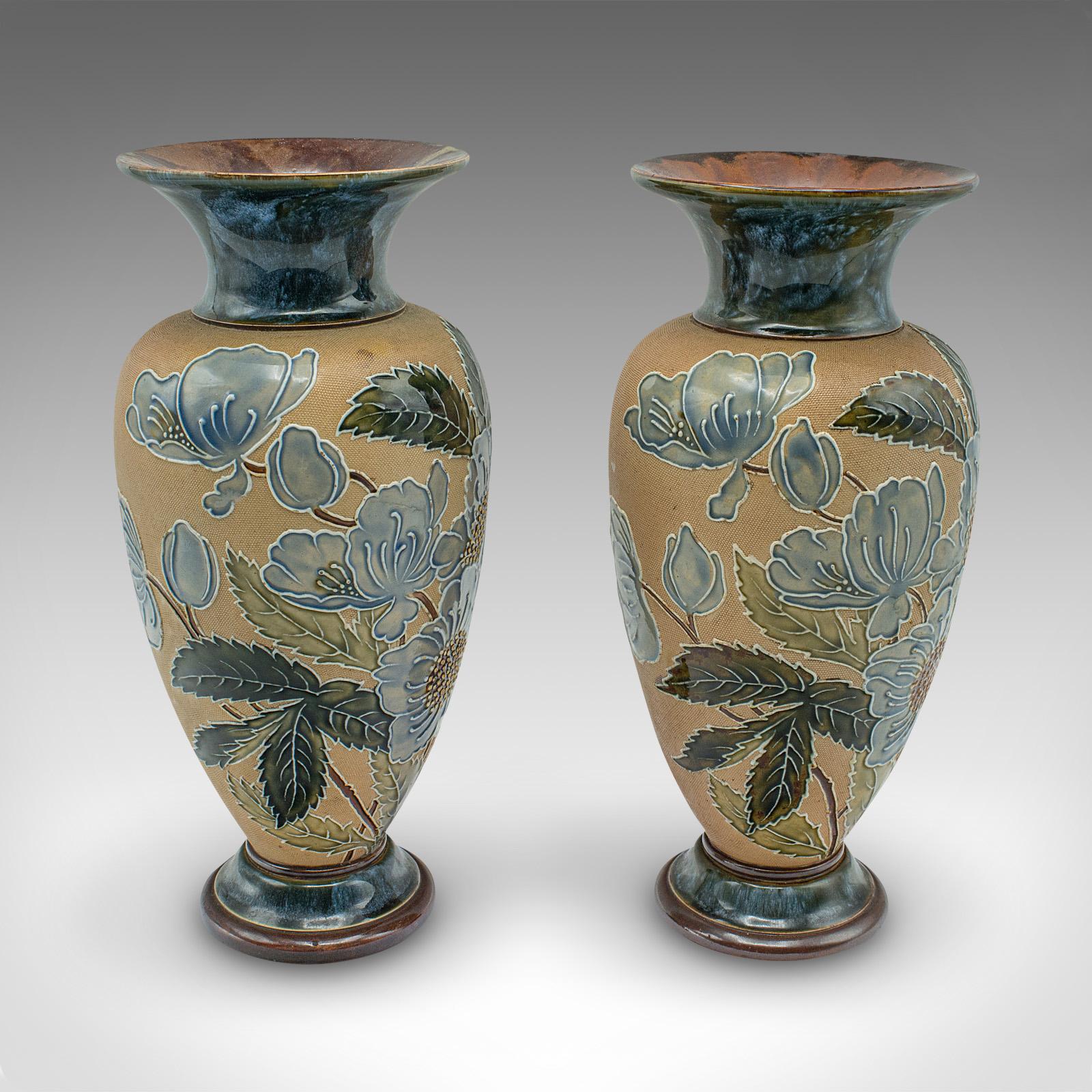 This is a pair of antique flower vases. An English, ceramic display urn, dating to the Edwardian period, circa 1910.

The Slater's Patent was the process of applying wet lace to the clay, with the resulting pattern leaving a textured pattern upon