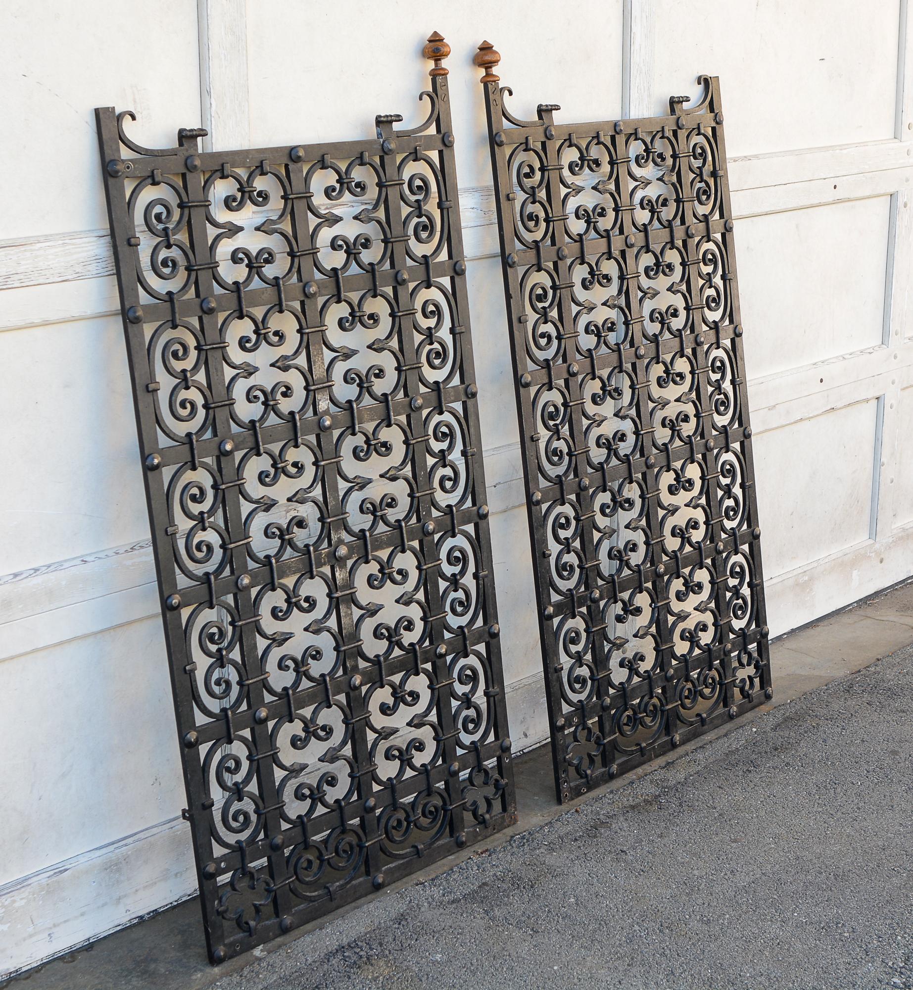 Pair of heavy forged iron gates. There is a lot of work put into these with large rivets and iron wrapping. The gates are from the Pittsburgh area originally. The side rails probably extended higher at one time but were cut down. The previous owner
