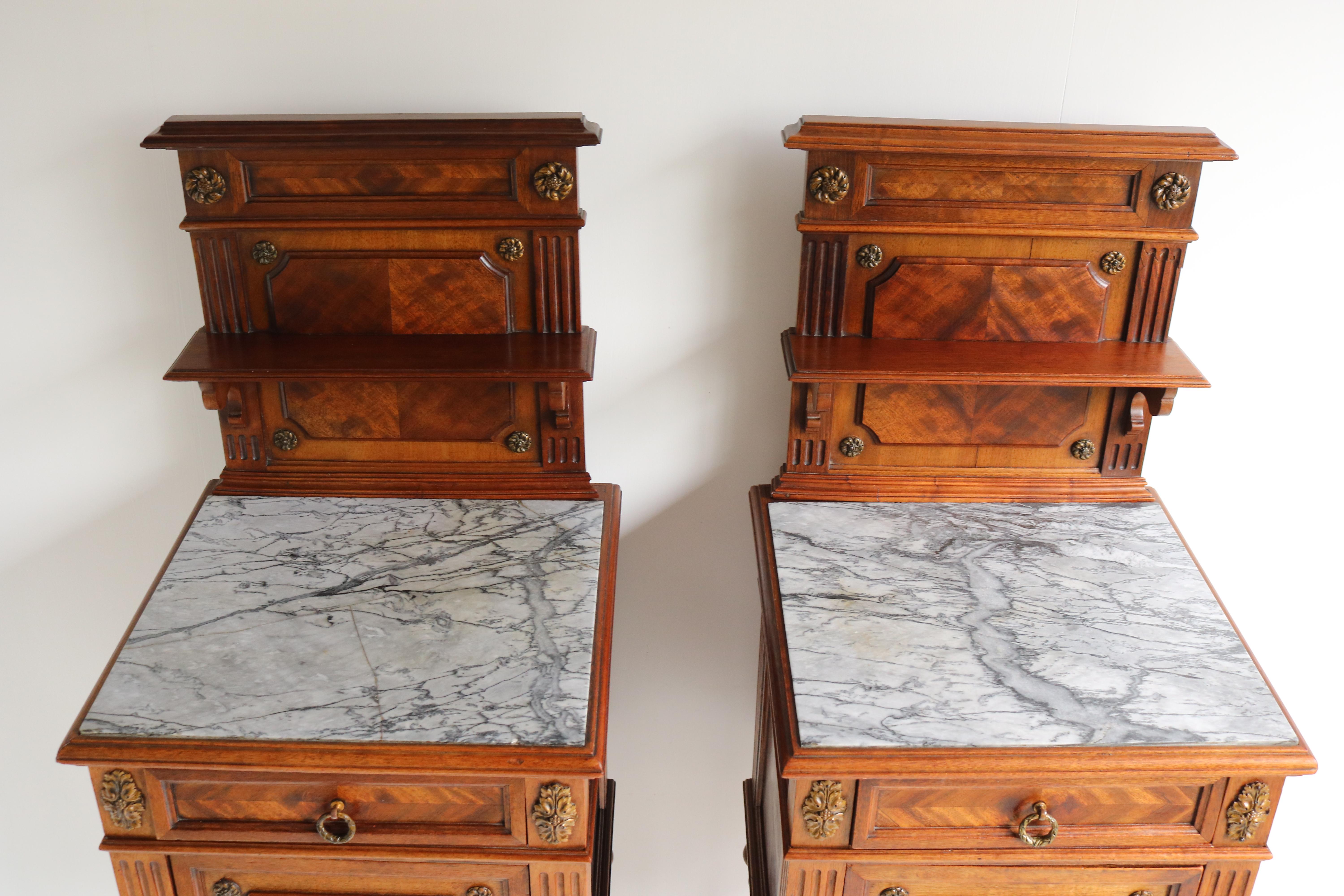 Impressive & stunning ! This pair of antique French 19th century night stands / bedside cabinets in Walnut. 
Amazing quality with inlaid walnut, bronze ornaments & grey marble tops. 
The bronze decorations combined with the walnut inlay and marble