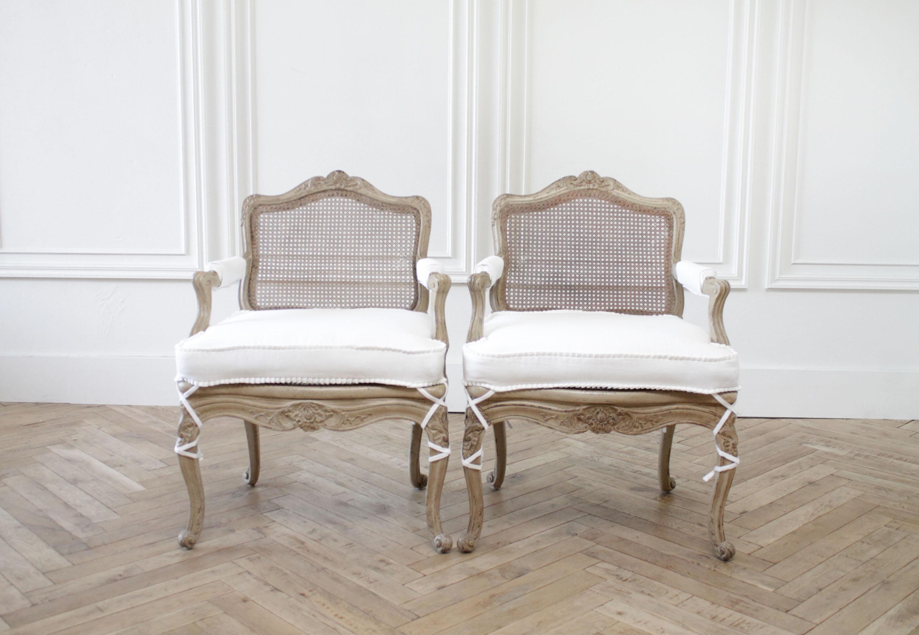 Pair of antique French armchairs in original painted finish and white linen
these chairs are painted in a putty grey tone, it is the perfect natural linen taupe color, with subtle distressing that is natural from original wear. The cane is
