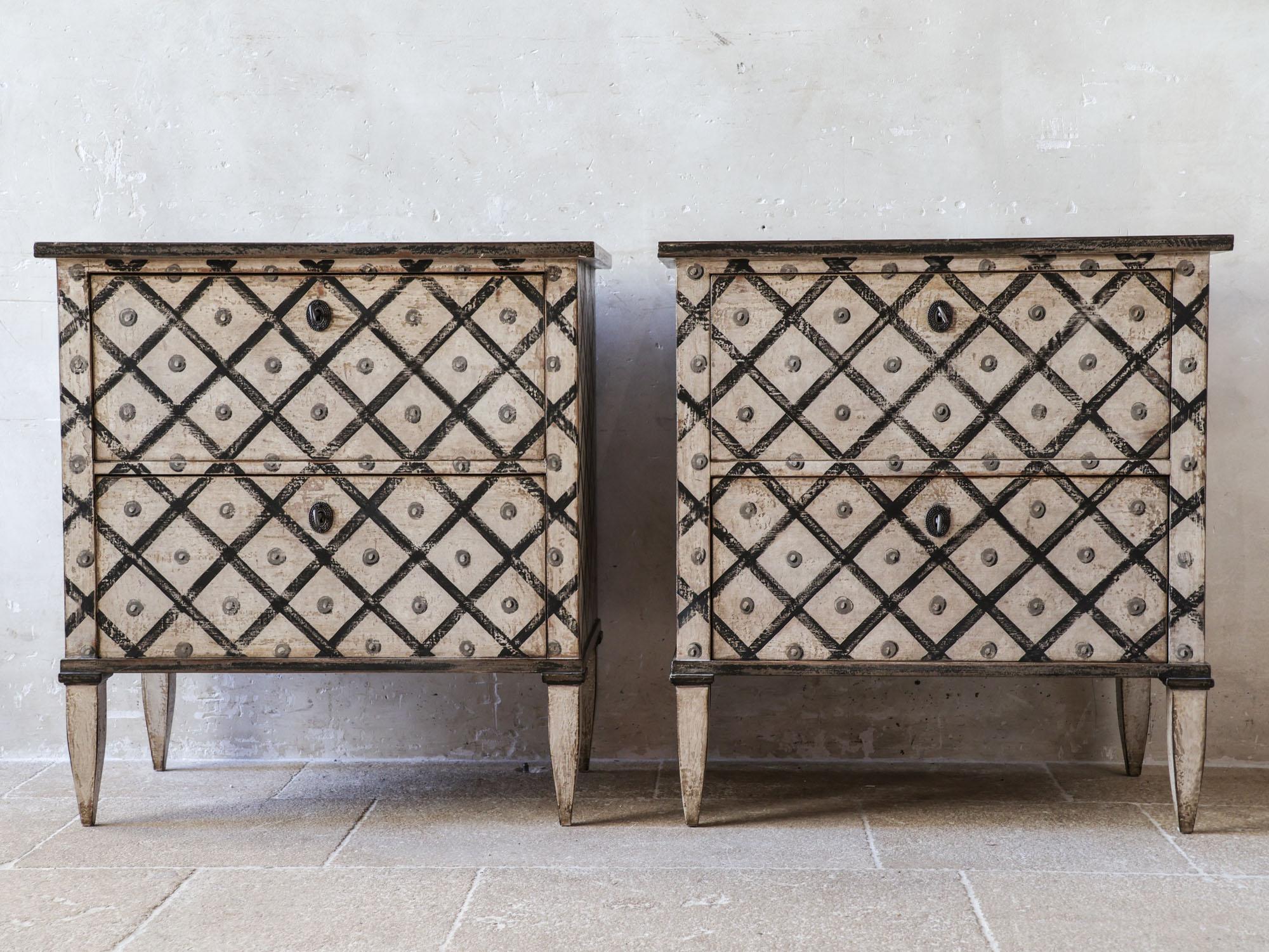 Set of two antique French chests of drawers from the 19th century. These commodes have been later repainted with a beautiful weathered white-cream patina and finished with a charming diamondpattern in black. They fit perfectly into various interior