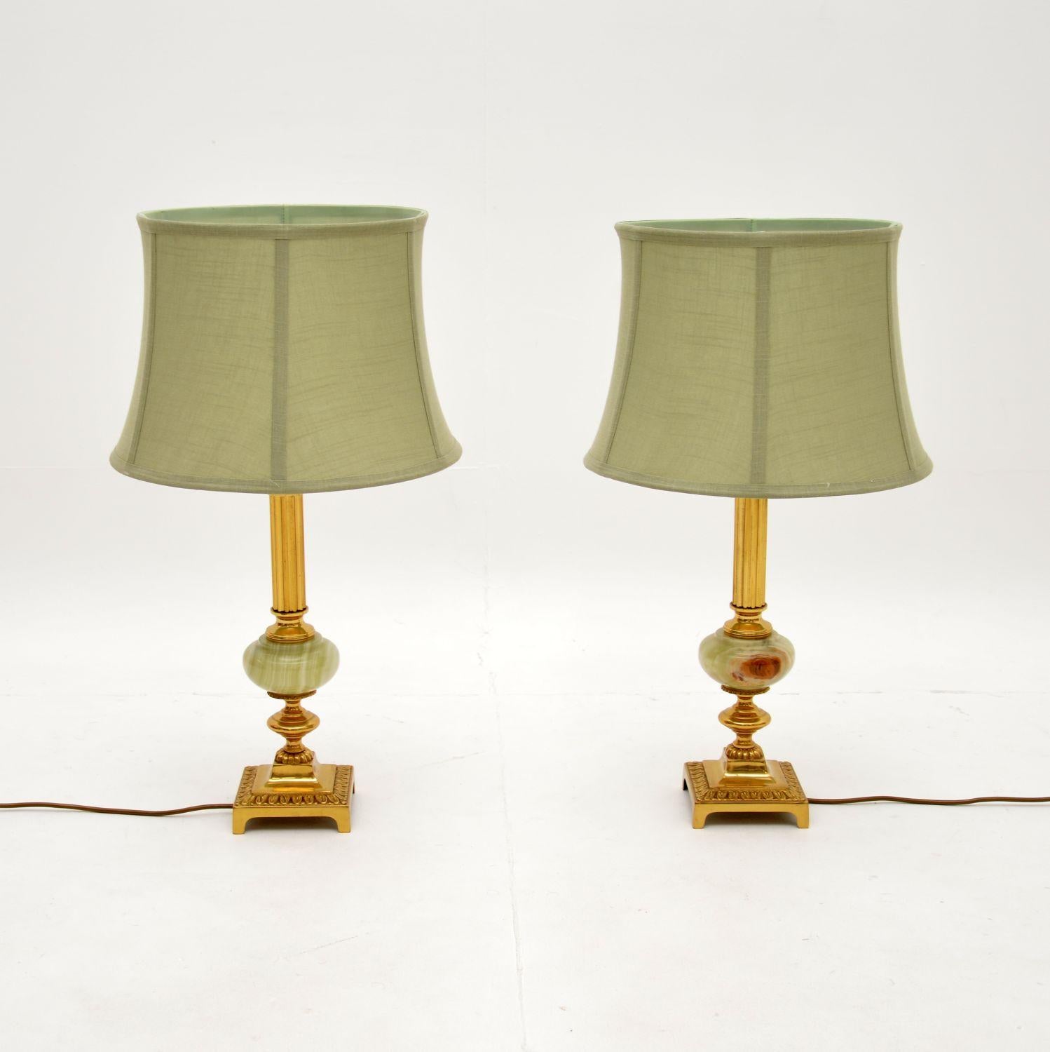 A wonderful pair of antique French brass and onyx table lamps, dating from around the 1930’s.

They are of superb quality and are a lovely size. They have fluted brass columns and sit on brass platform bases, joined together by elliptical onyx