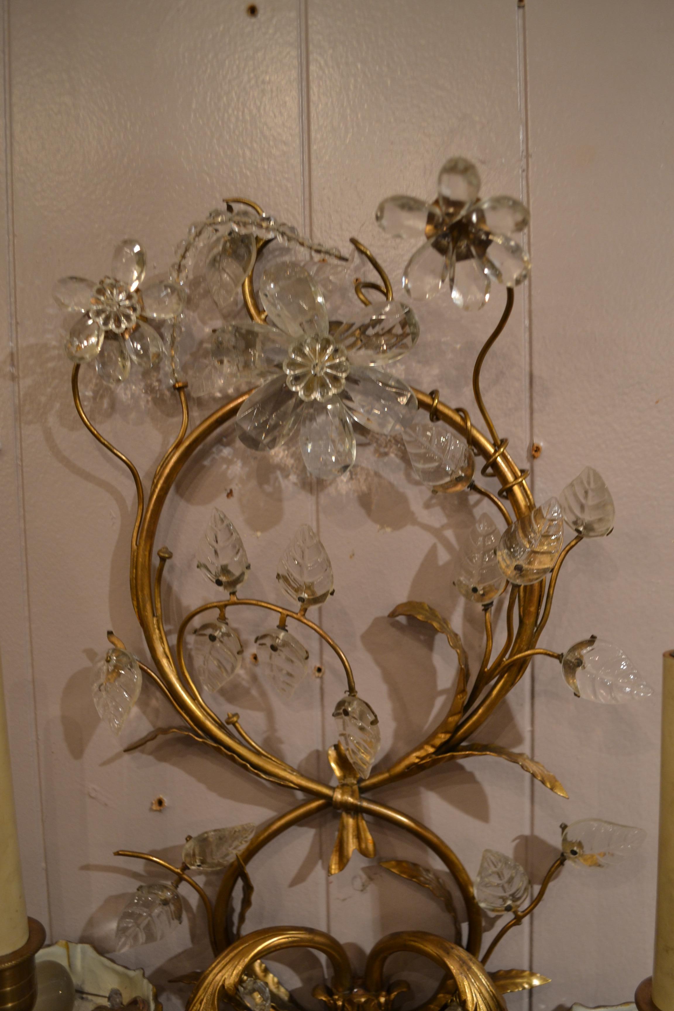 Pair of antique French bronze and crystal sconces with delicate work.