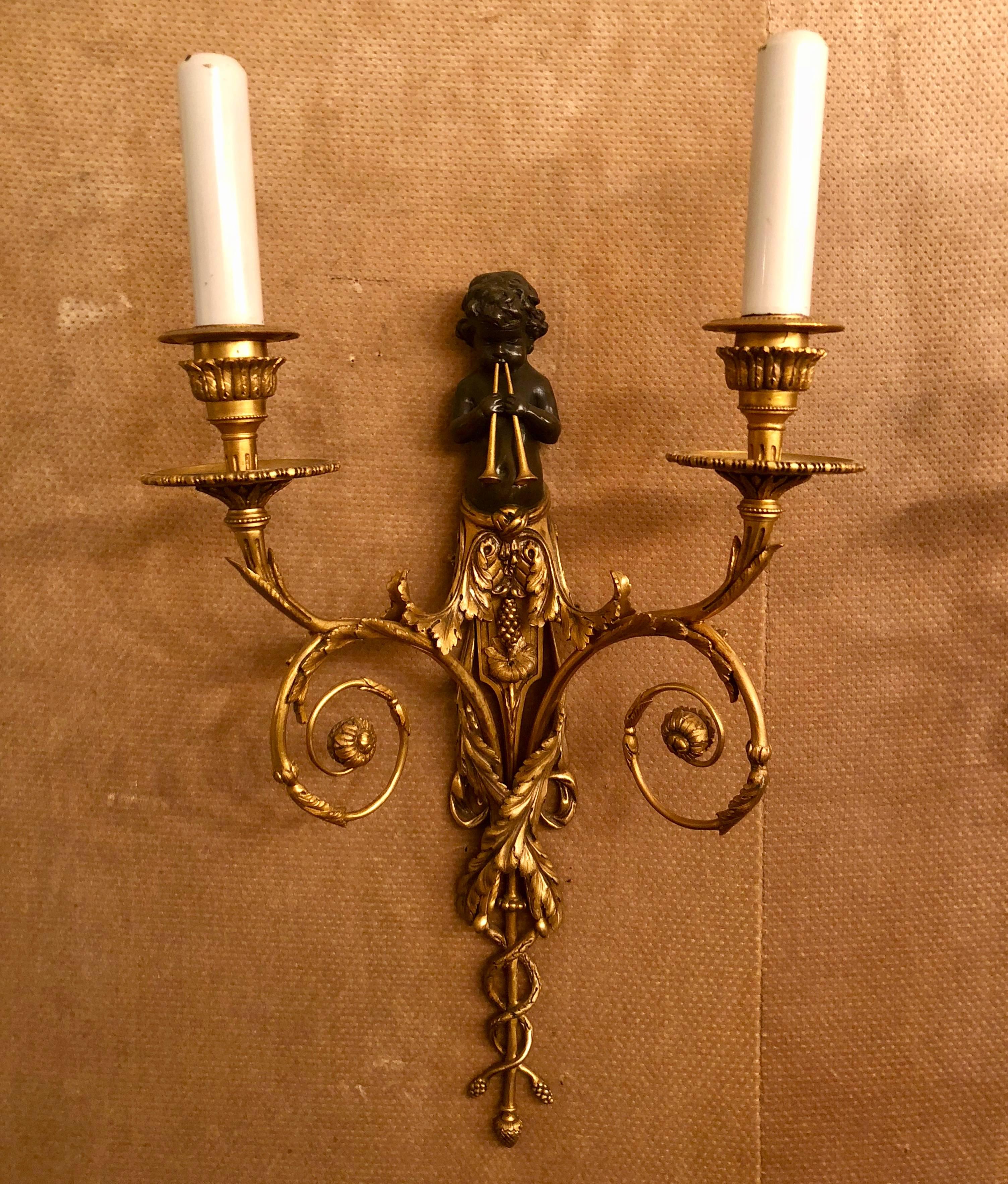 Pair of antique French patinated bronze and bronze doré sconces, circa 1880.