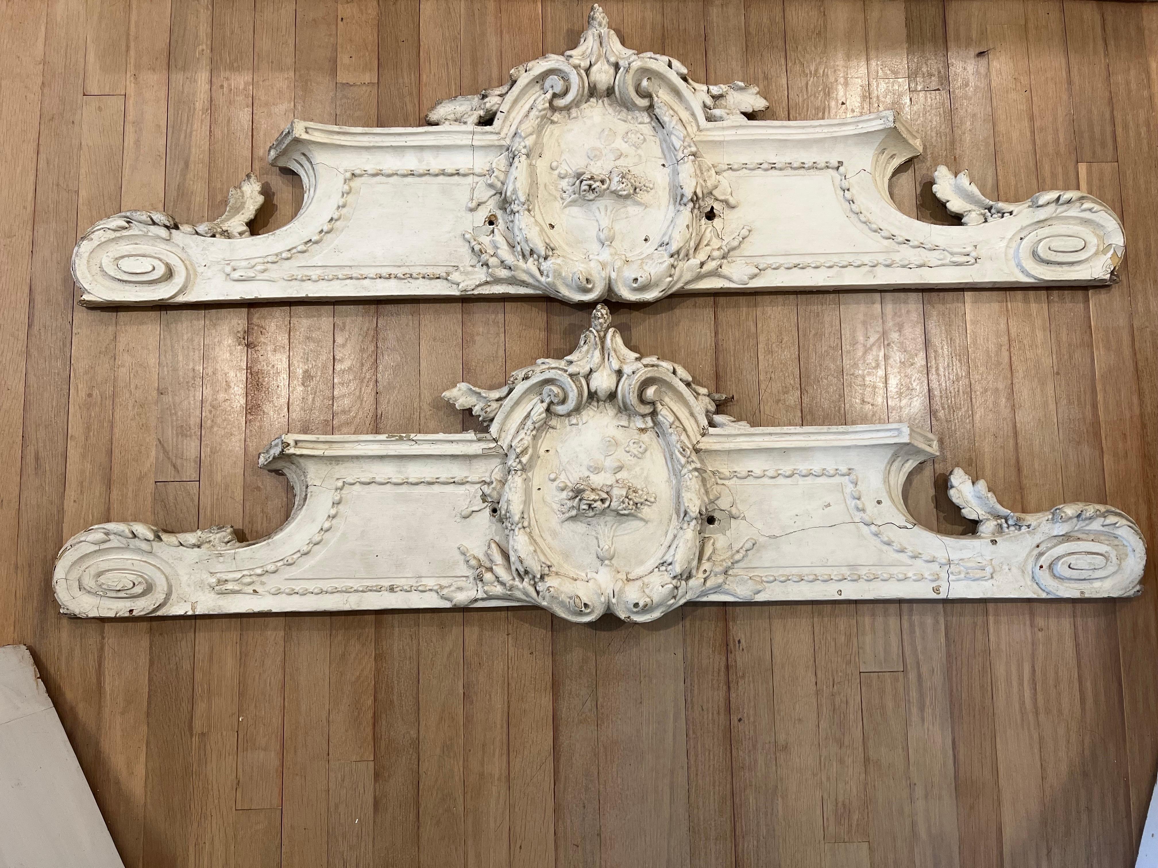 Gorgeous pair of Antique Carved French Pediments in a creamy white patina.  
Could be used on the wall as a relief or over a doorway to ad interest.  

See images for condition.  These are old and show signs consistent as such. 
