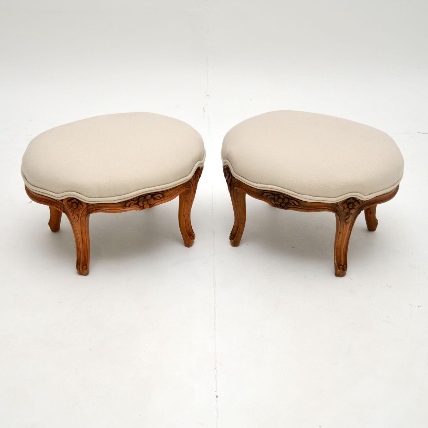 A beautiful pair of small oval antique French style foot stools, which I would date from around the 1920-30’s period.

They are of excellent quality, the bases are solid walnut with crisp and intricate floral carving.

The condition is lovely