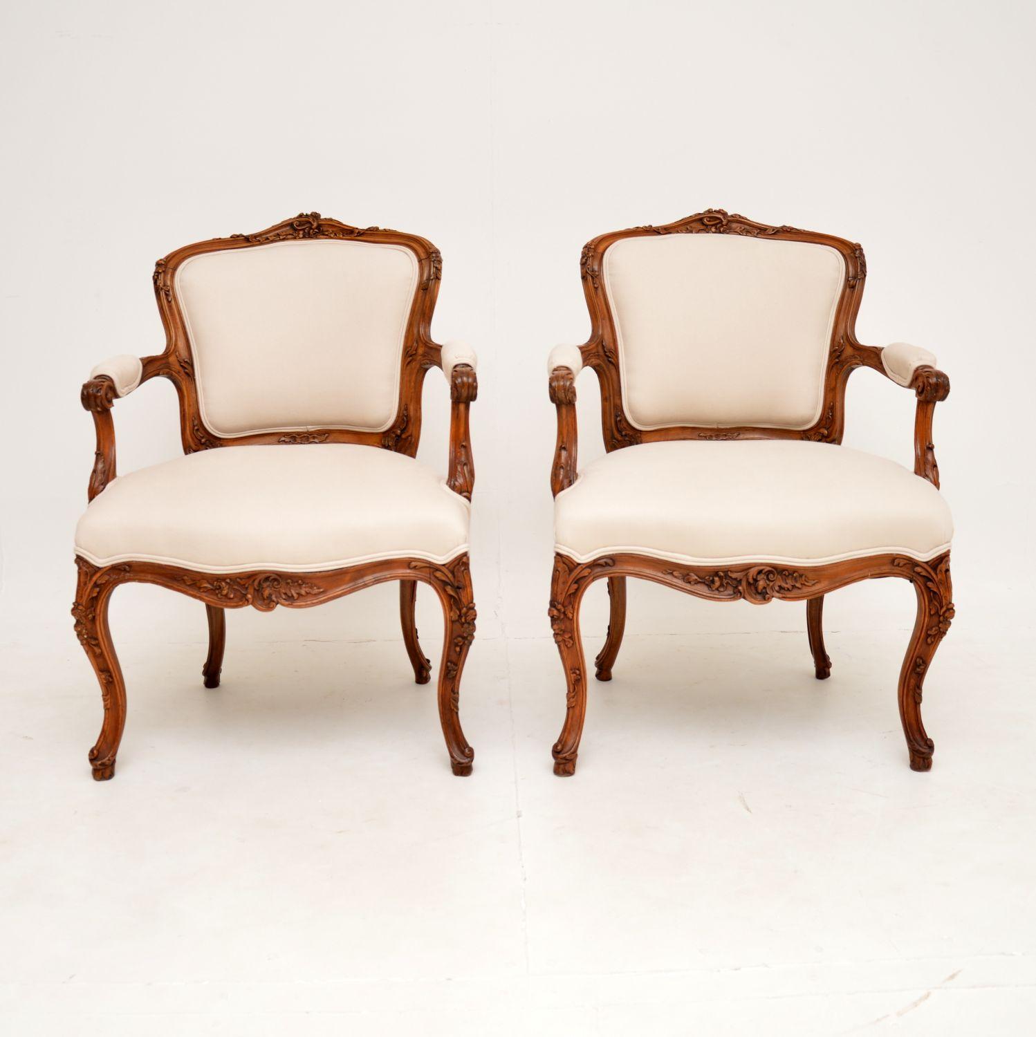 An incredible pair of antique French walnut salon armchairs with beautiful carvings. They were made in France, and I would date them from around the 1850-60’s period.

The quality is outstanding, with profuse, deep and intricate floral carving
