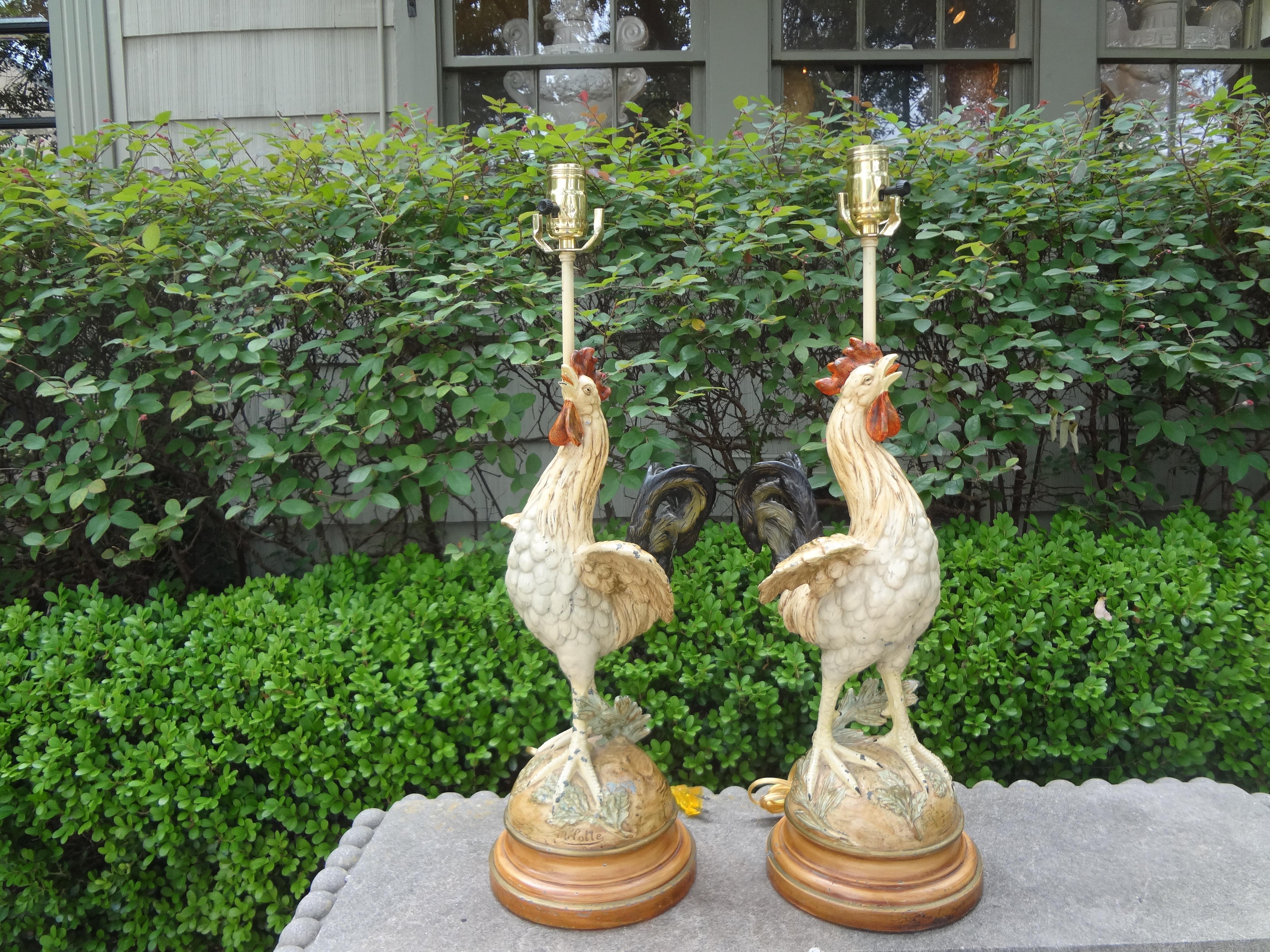 Pair of antique French cast iron rooster lamps.
Lovely pair of French polychromed cast iron rooster lamps. These French lamps are executed in a beautiful soft palette mounted on wood bases. Featured lamps are artist-signed and have been newly wired