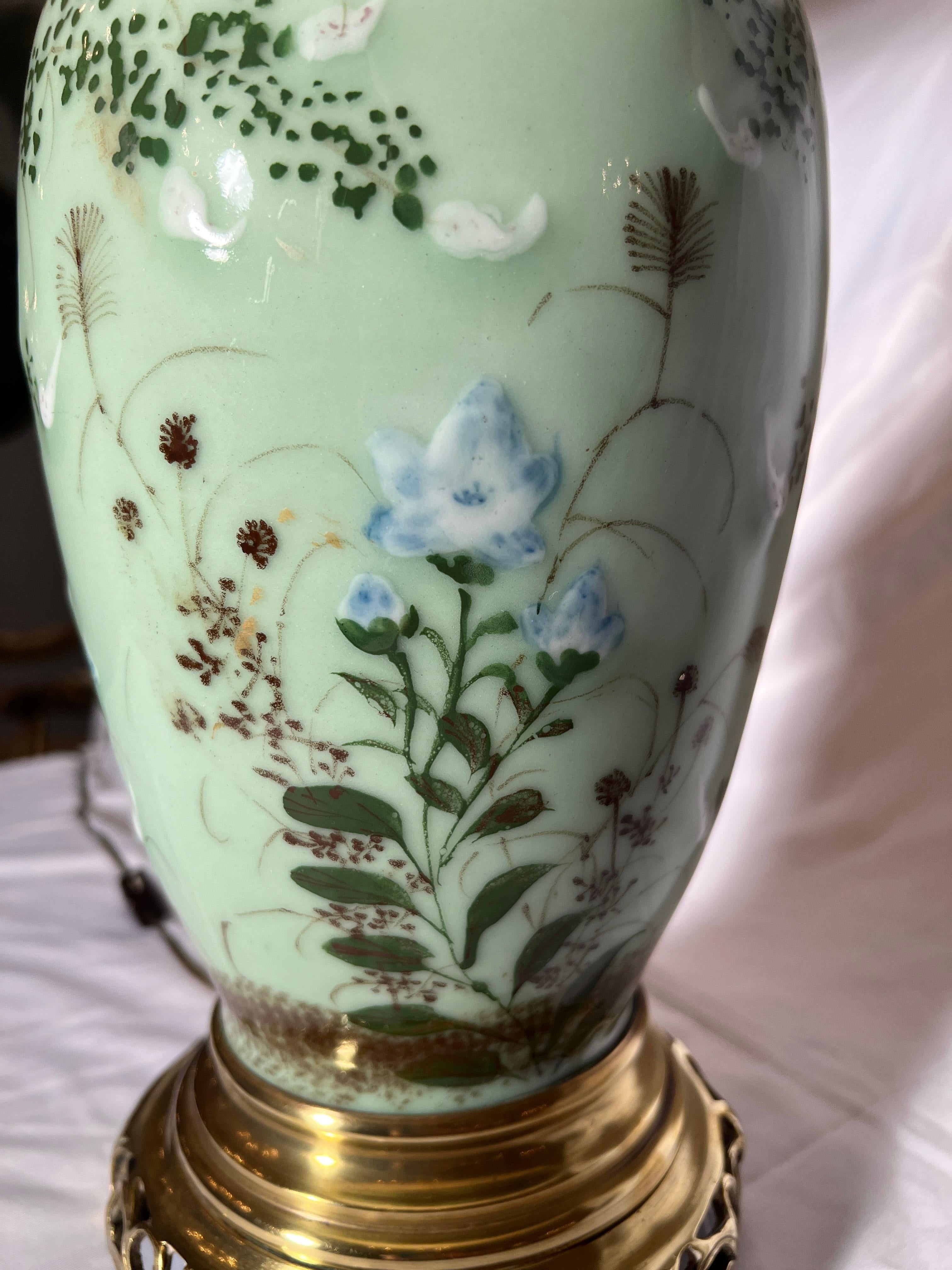 A lovely pair of celadon lamps with floral decoration.
