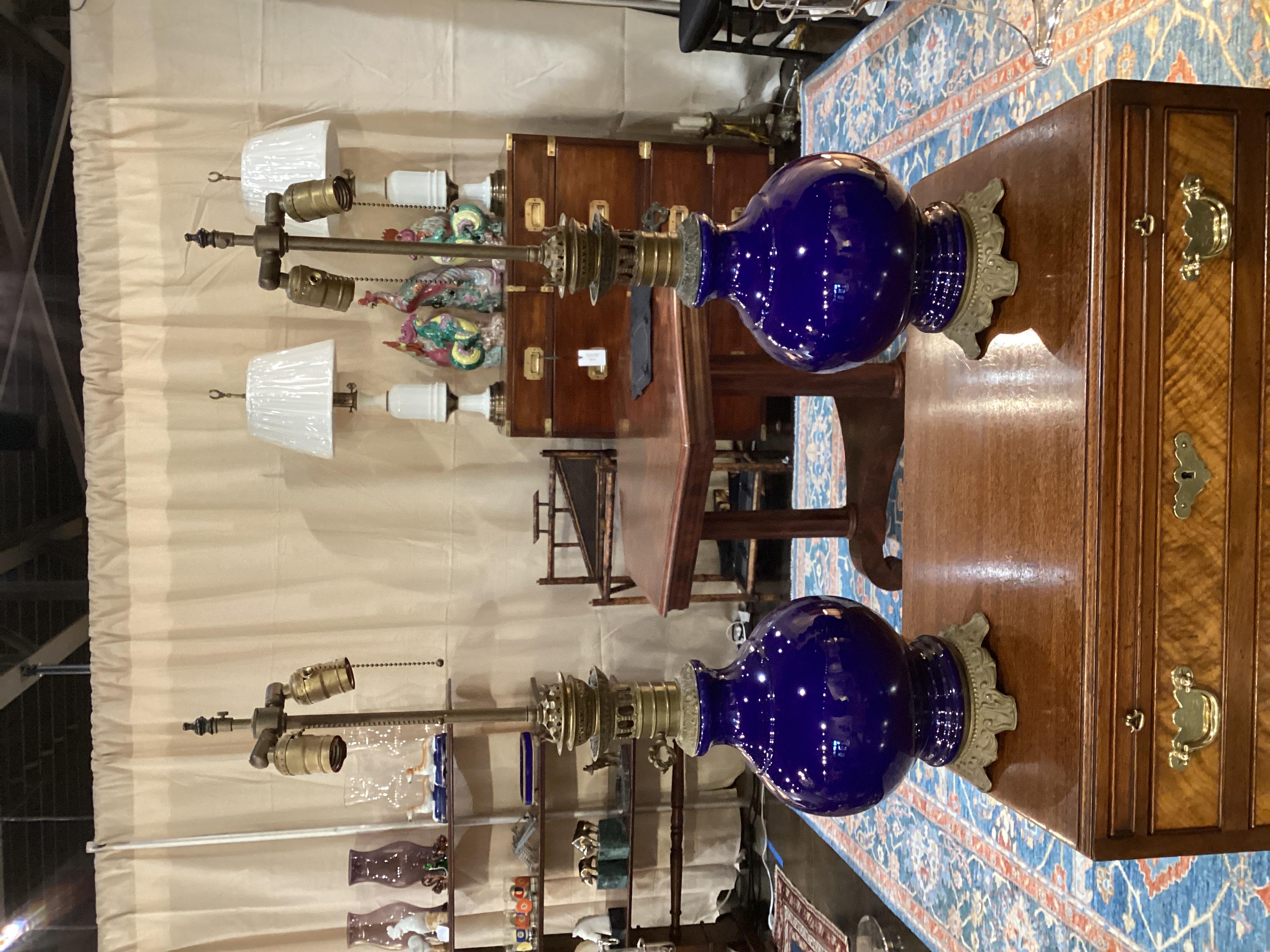 Pair of Antique French Cobalt Blue Ceramic Lamps. These were originally used as oil lamps and were later converted to electricity. Wired and in good working condition with double cluster lights.