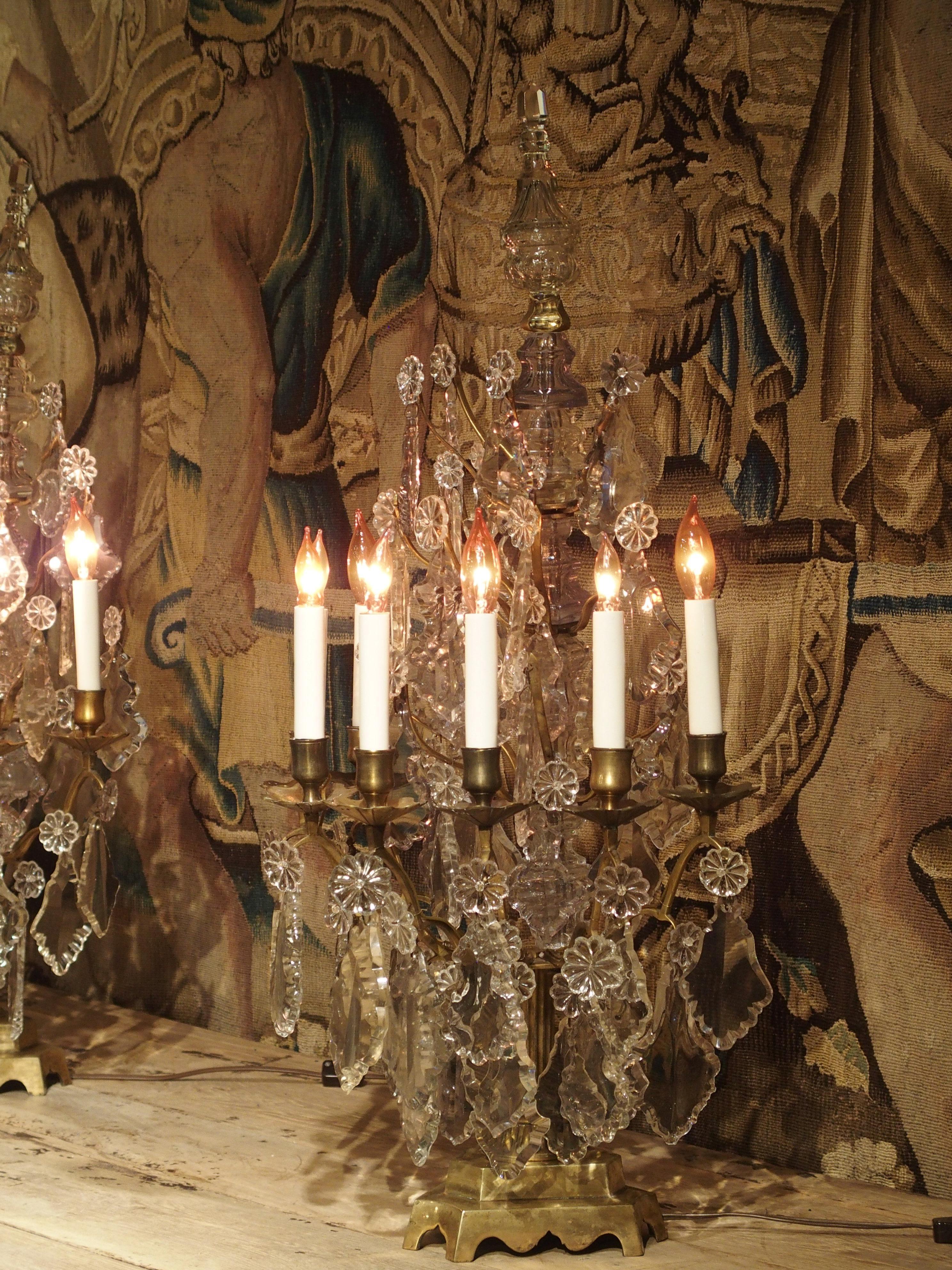 This lovely pair of crystal and bronze girandoles are from France, circa 1890. A girandole is a branched candelabra that resembles a small chandelier. Often produced as pairs, the first girandoles were seen in the latter half of the 17th