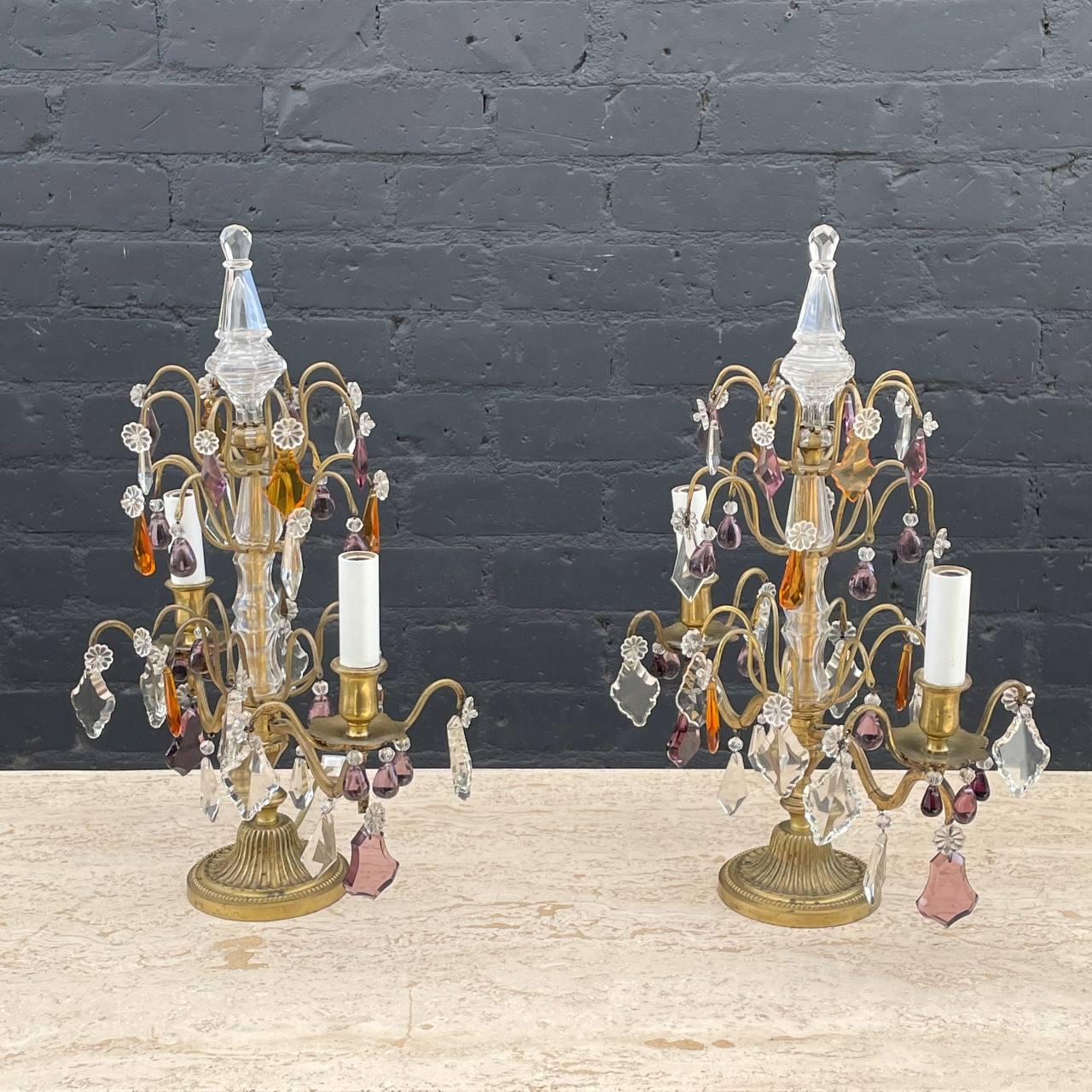 Each girandole features a delicate bronze frame with an assortment of faceted prisms in various shapes , colors and sizes.

Wired and in working condition, each girandole requires 2 candelabra bulbs.

Decorative accent fixtures, perfect for