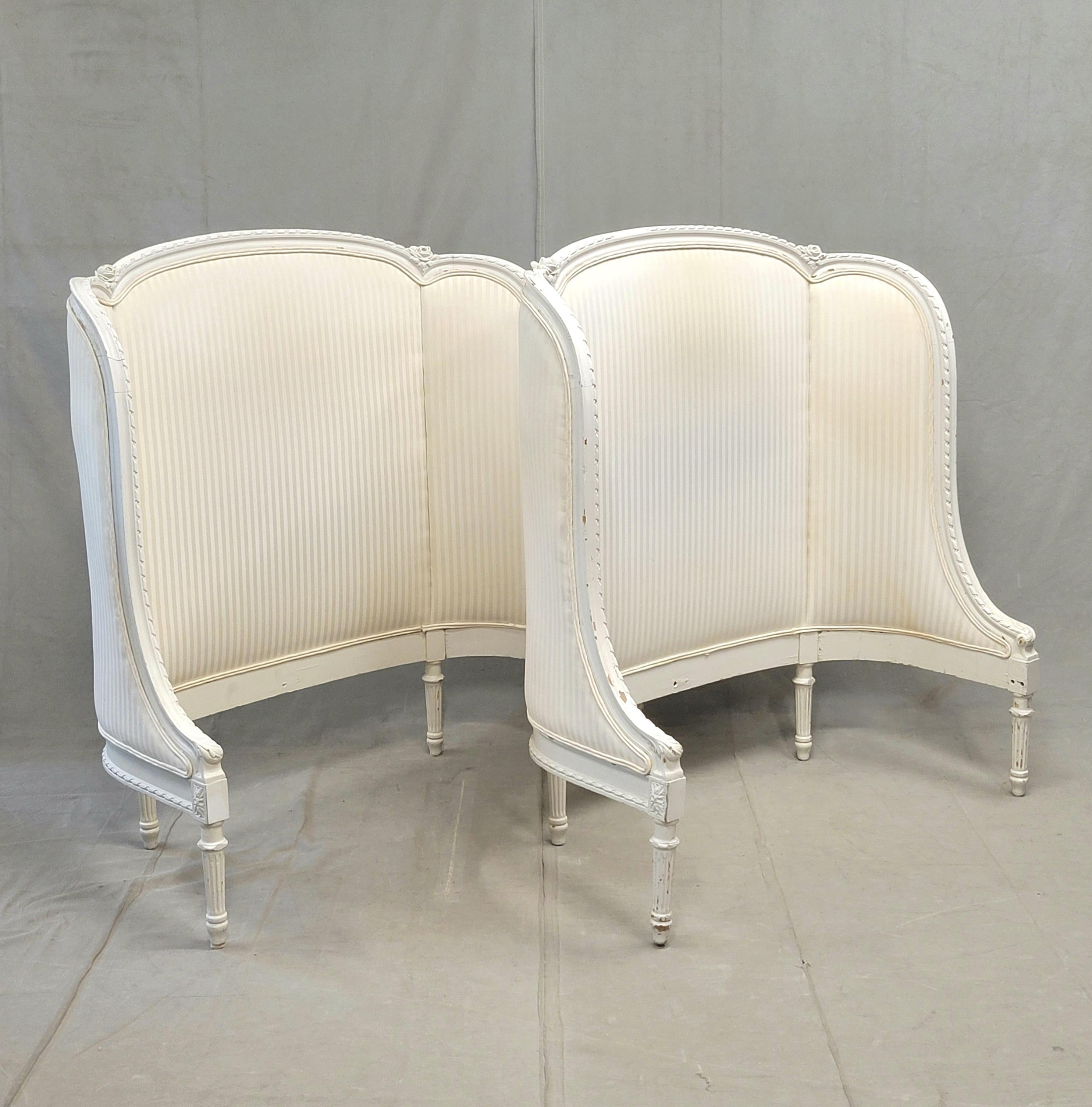 An absolutely beautiful pair of vintage or antique traditional French curved twin headboards. The white paint on the wood is missing is some areas but this adds to the rustic charm of this pair. Note the carved wood roses and ornamental carved