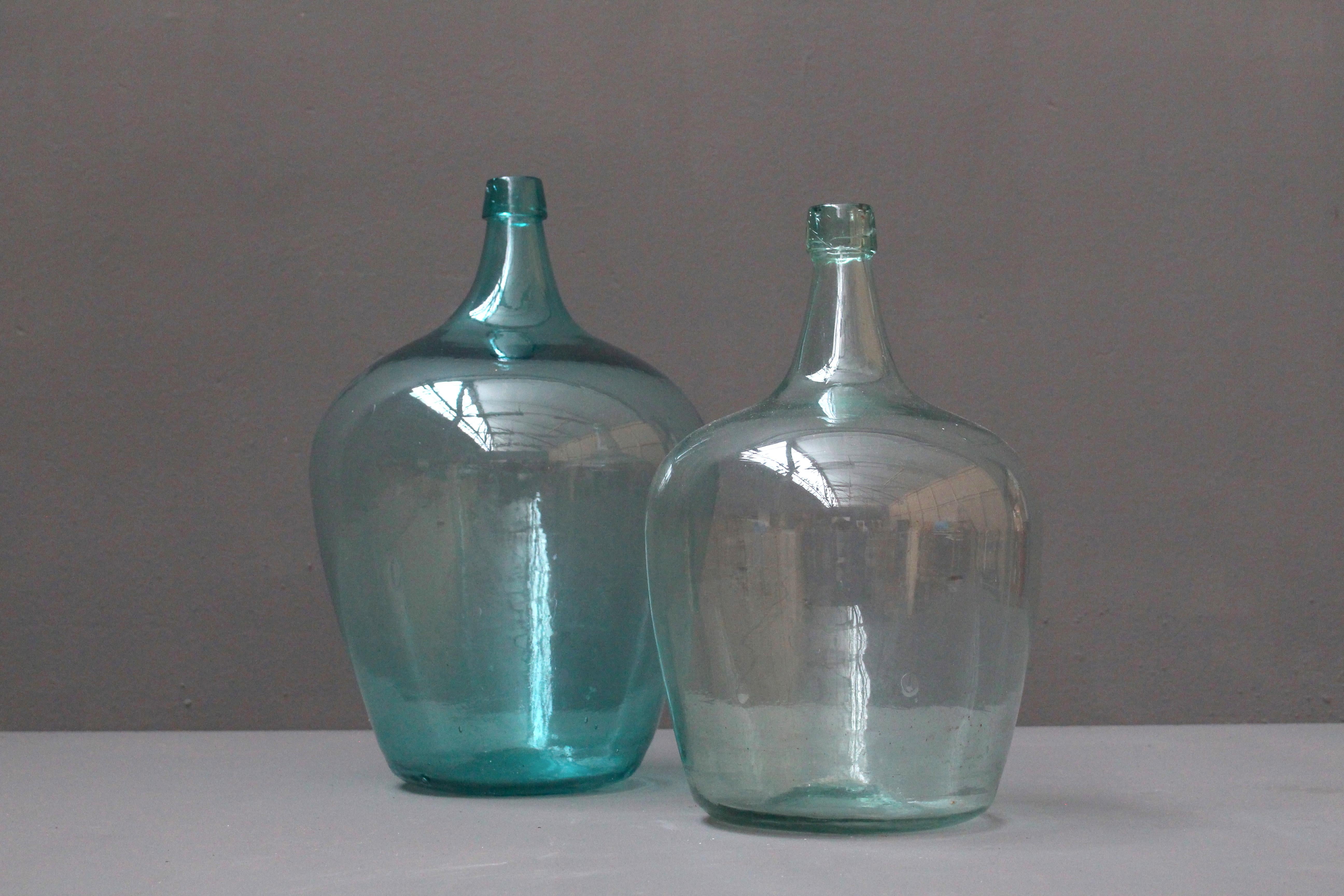Lovely pair of French hand blown glass wine bottles from circa 1900.
Very decorative pieces.
These bottles have some beautiful air bubbles in the glass.
The turquoise color is very unique.