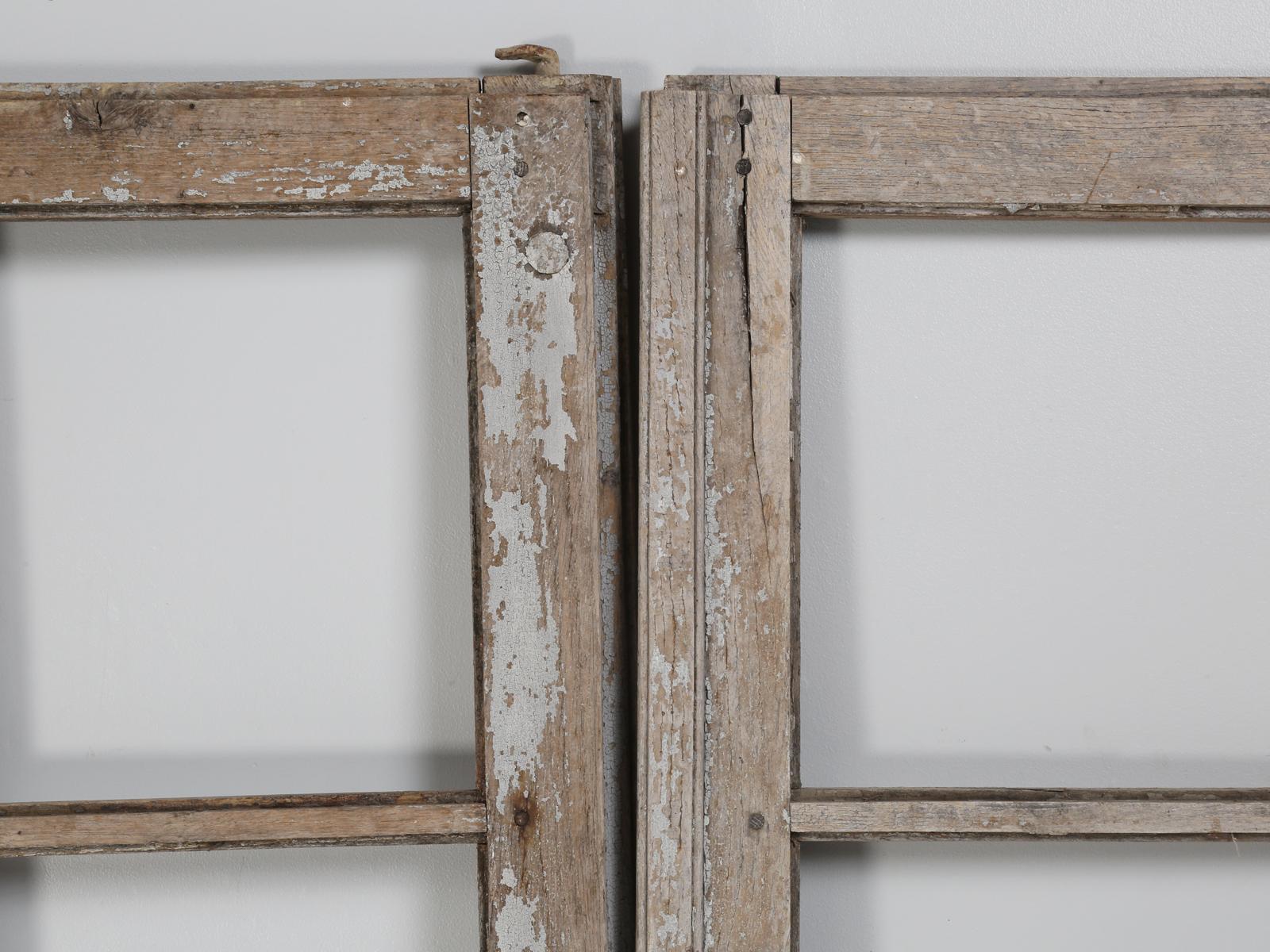 Pair of original paint antique French doors, in as found condition and although the doors are in rough shape, they are very restorable and have “great” original hardware. We would classify the pair of Antique French Doors as decorative and not very