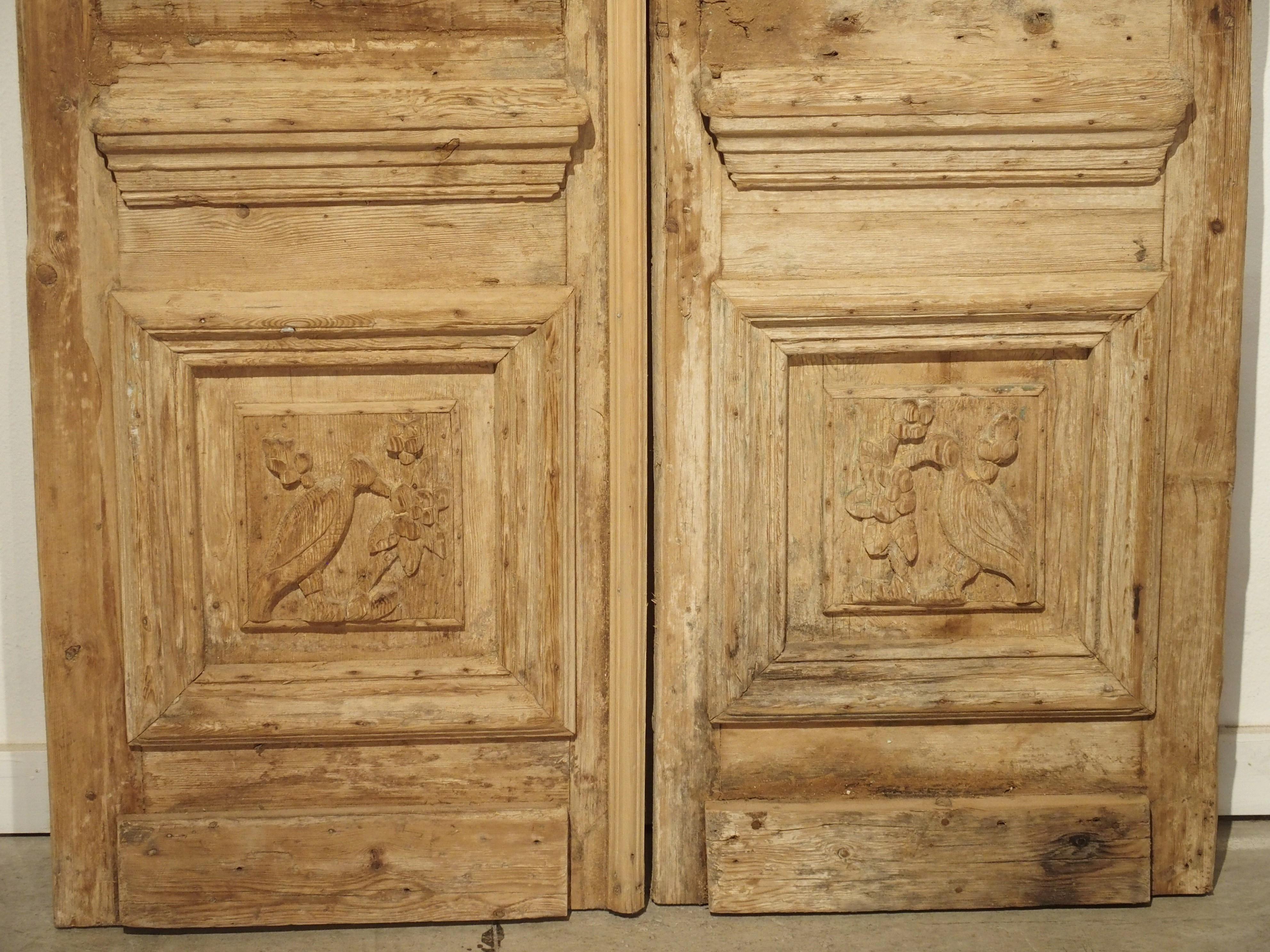 These antique doors are made of carved pine, and were salvaged from a property in Egypt, likely close to Cairo. The lower panels show unique carvings of birds, while the upper sections are more architectural in nature.

In the 19th century, France