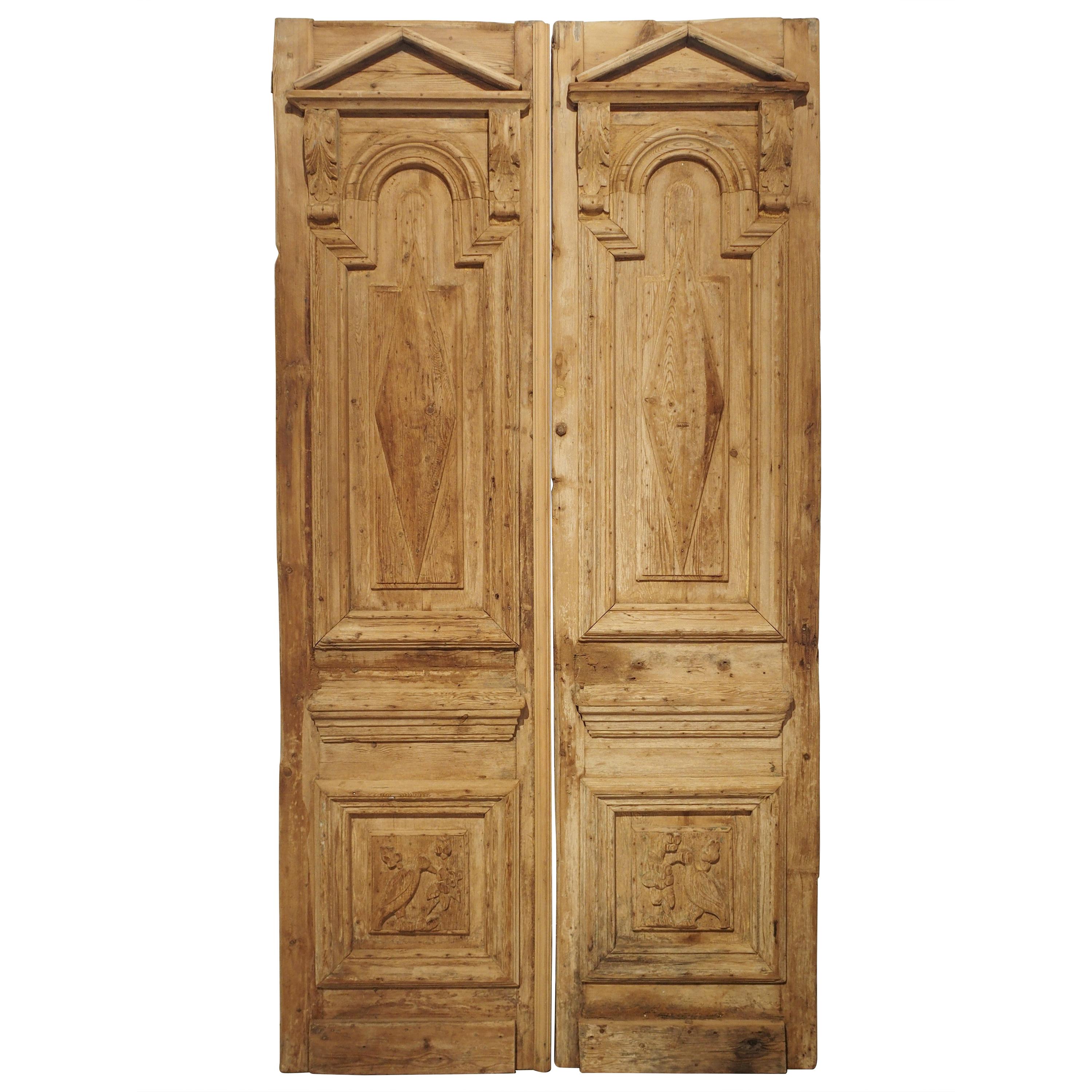 Pair of Antique French Egyptian Pine Doors with Carved Bird Motifs